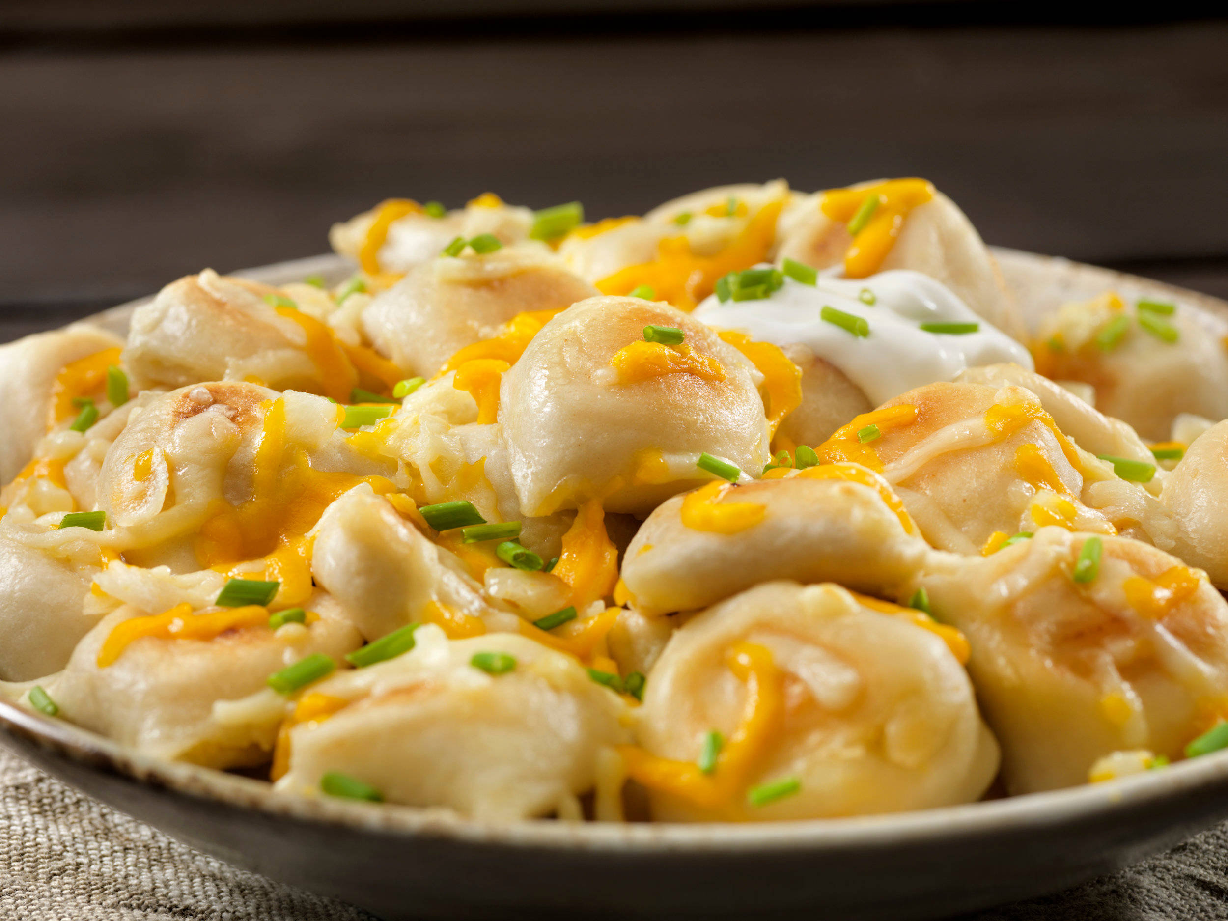 cheesy pierogi dish, golden dumplings, melted cheddar cheese, Full HD Desktop Wallpaper