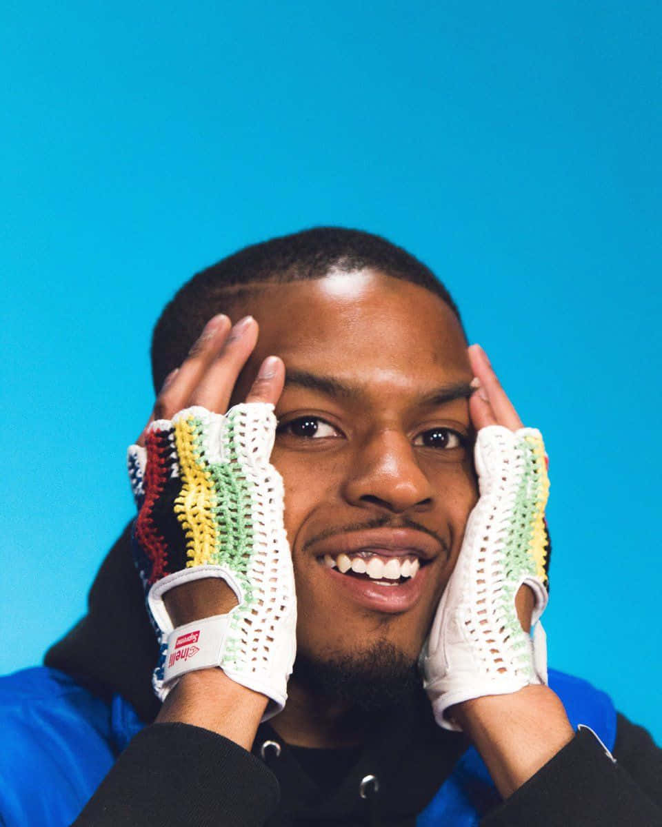 Pierre Bourne, colorful fingerless gloves, solid blue studio background, SD Phone Wallpaper