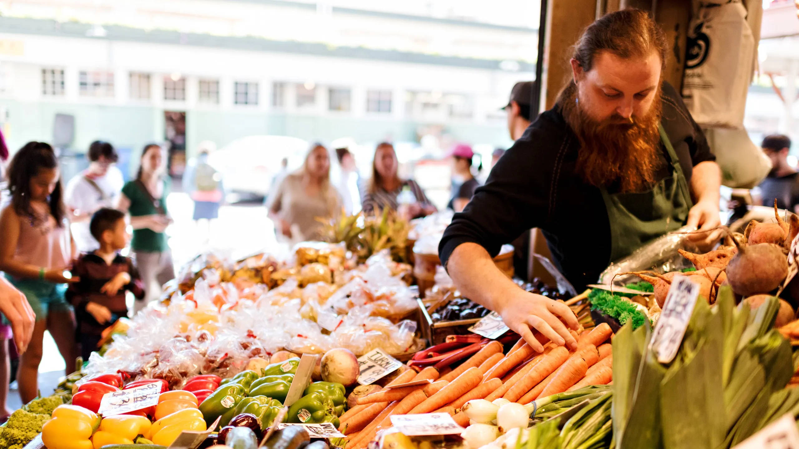 Pike Place Market, fresh produce stall, bearded vendor, 2K Desktop Wallpaper
