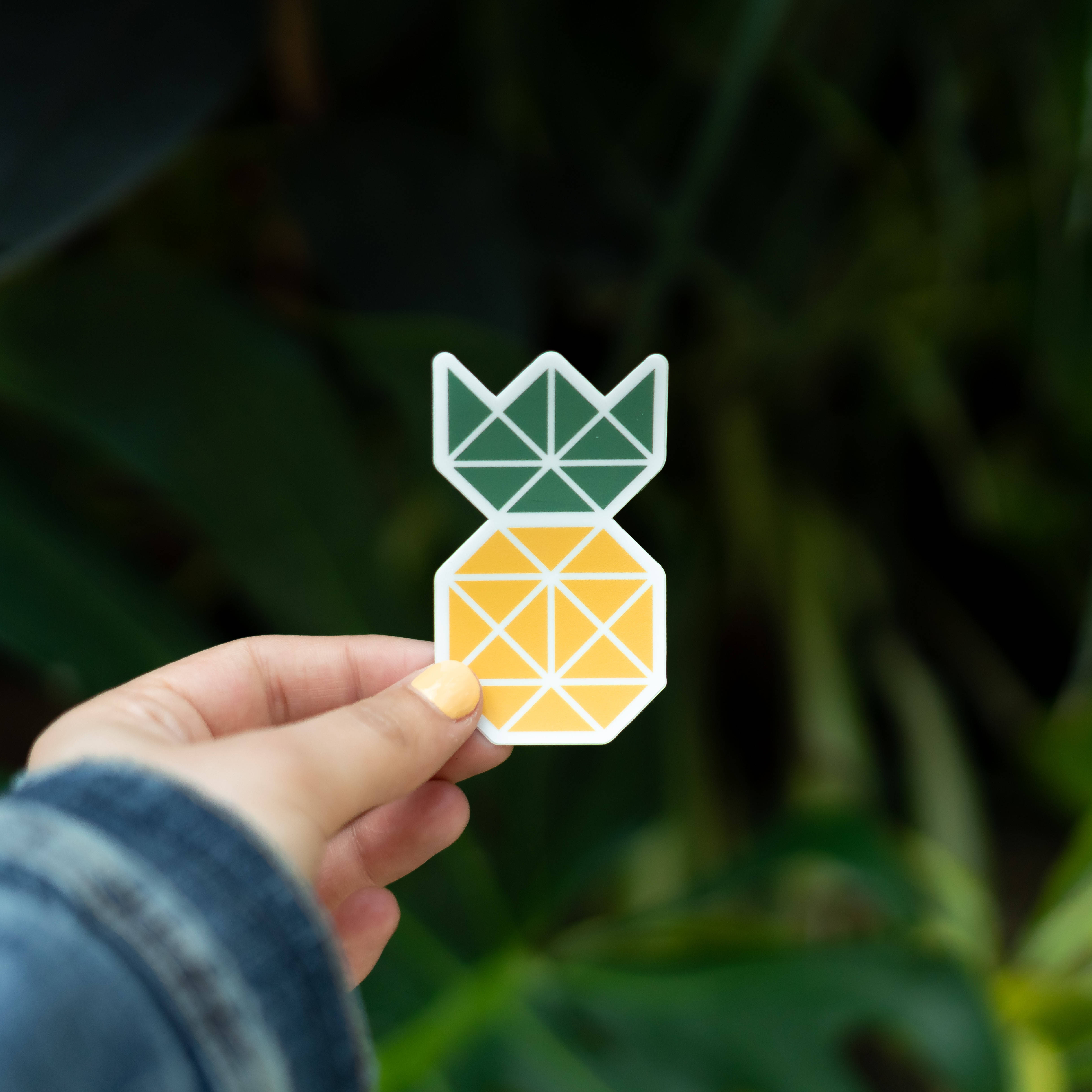 geometric pineapple sticker, green and yellow triangles, blurred green leafy background, 4K Desktop Wallpaper