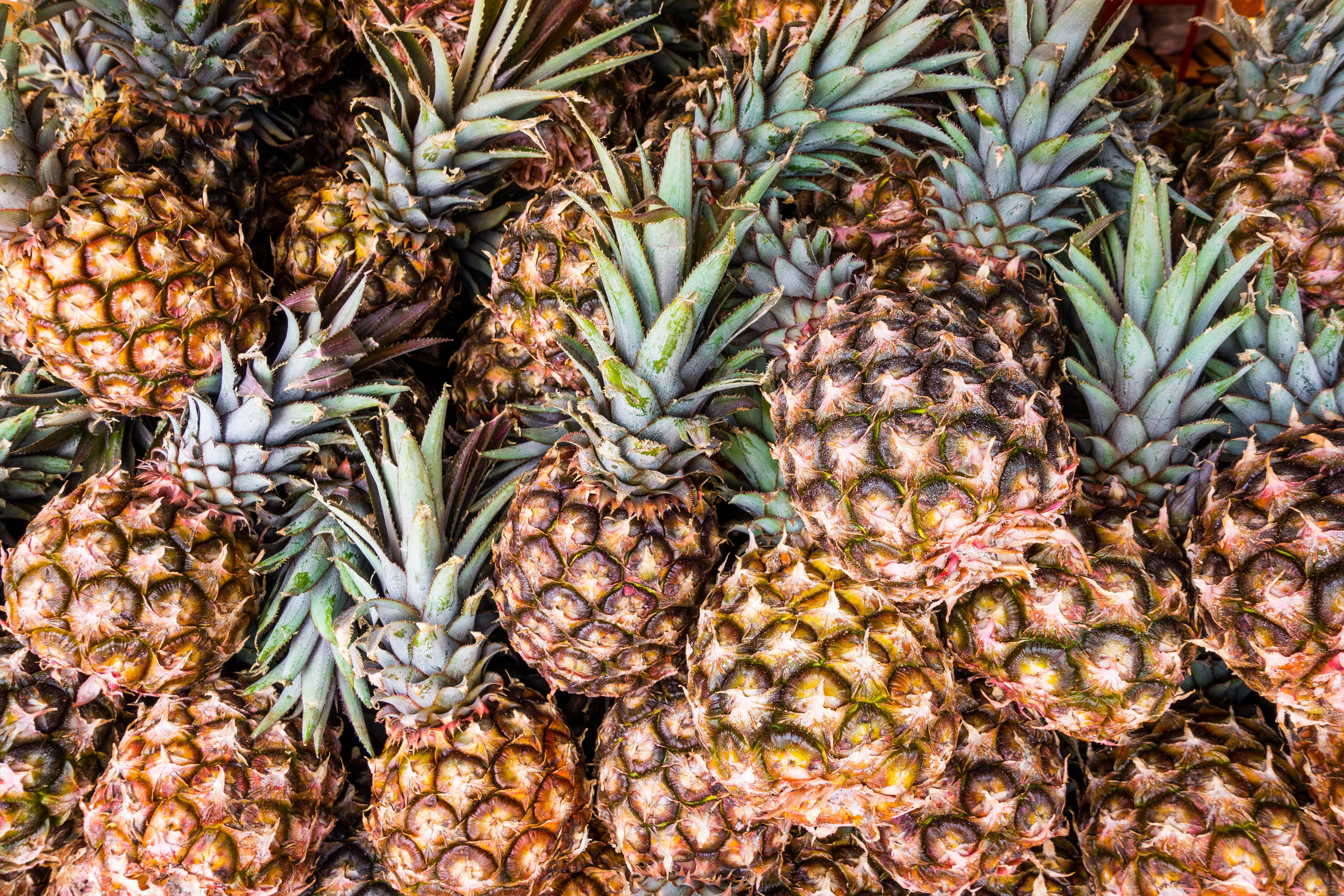 ripe pineapple, textured brown crowns, green spiky leaves, 4K Desktop Wallpaper
