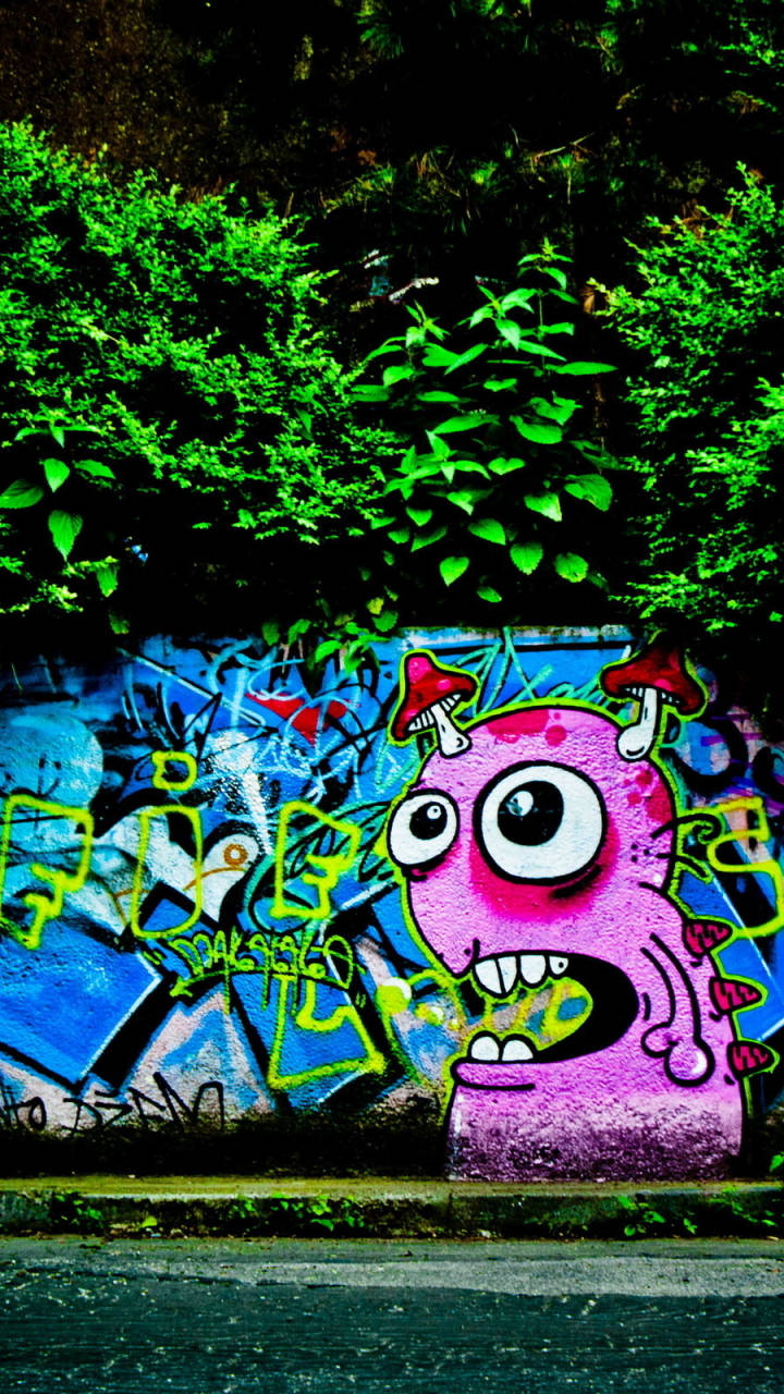 Pink Blue, graffiti-covered wall, lush green bushes, HD Phone Wallpaper