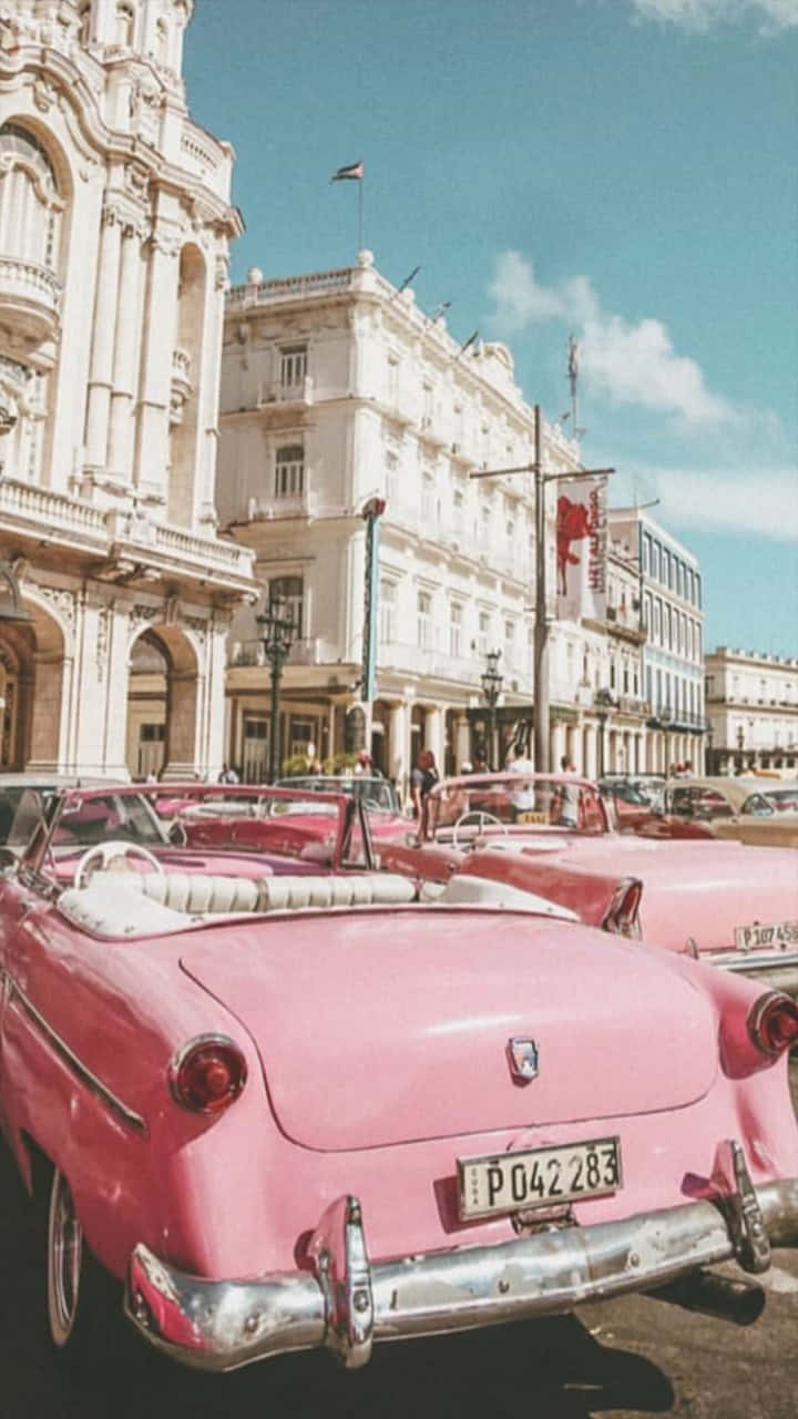 pink vintage convertible, sunlit street, ornate colonial buildings, HD Phone Wallpaper