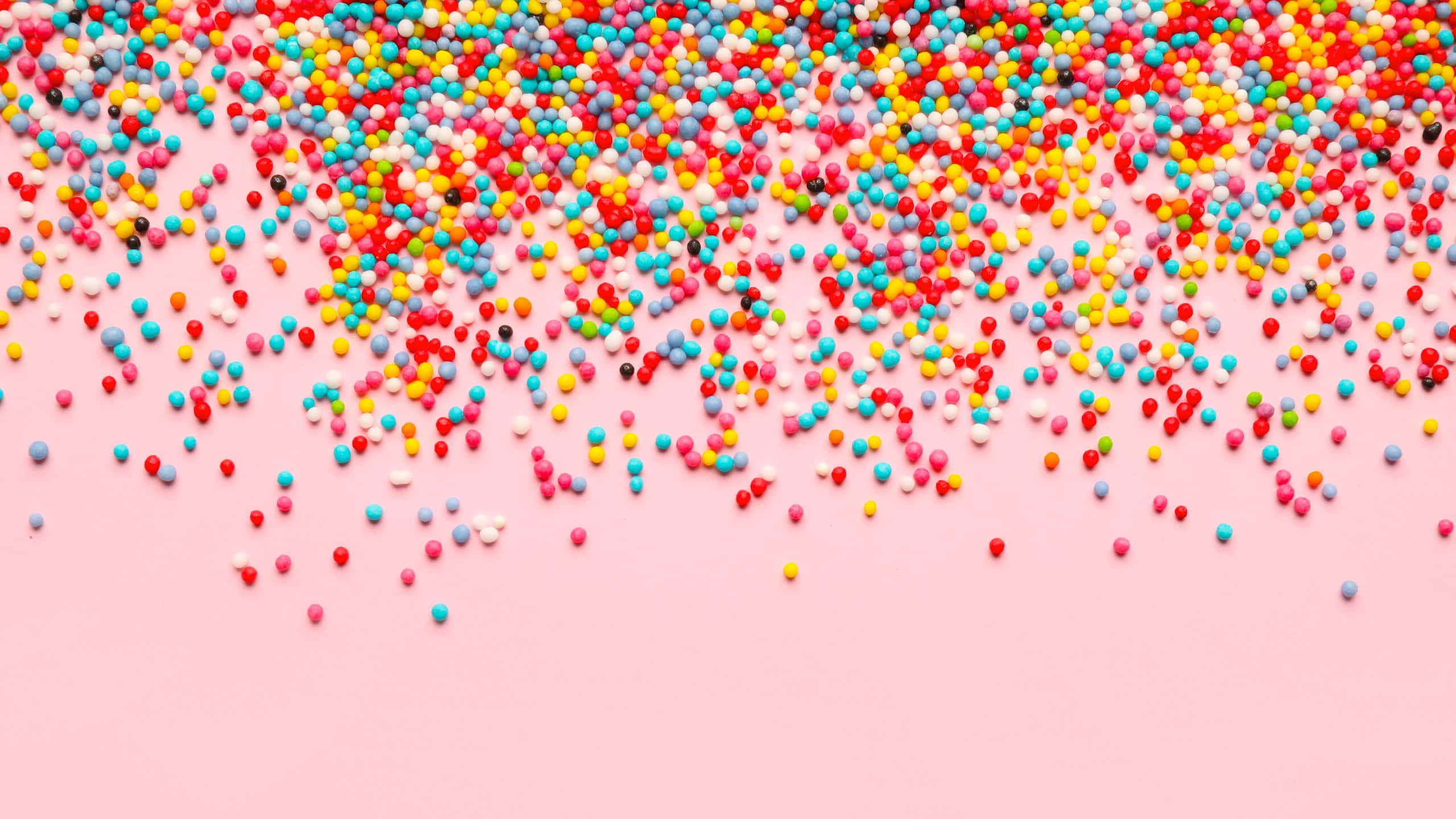 colorful sprinkles, rainbow sprinkles, soft pink background, 2K Desktop Wallpaper
