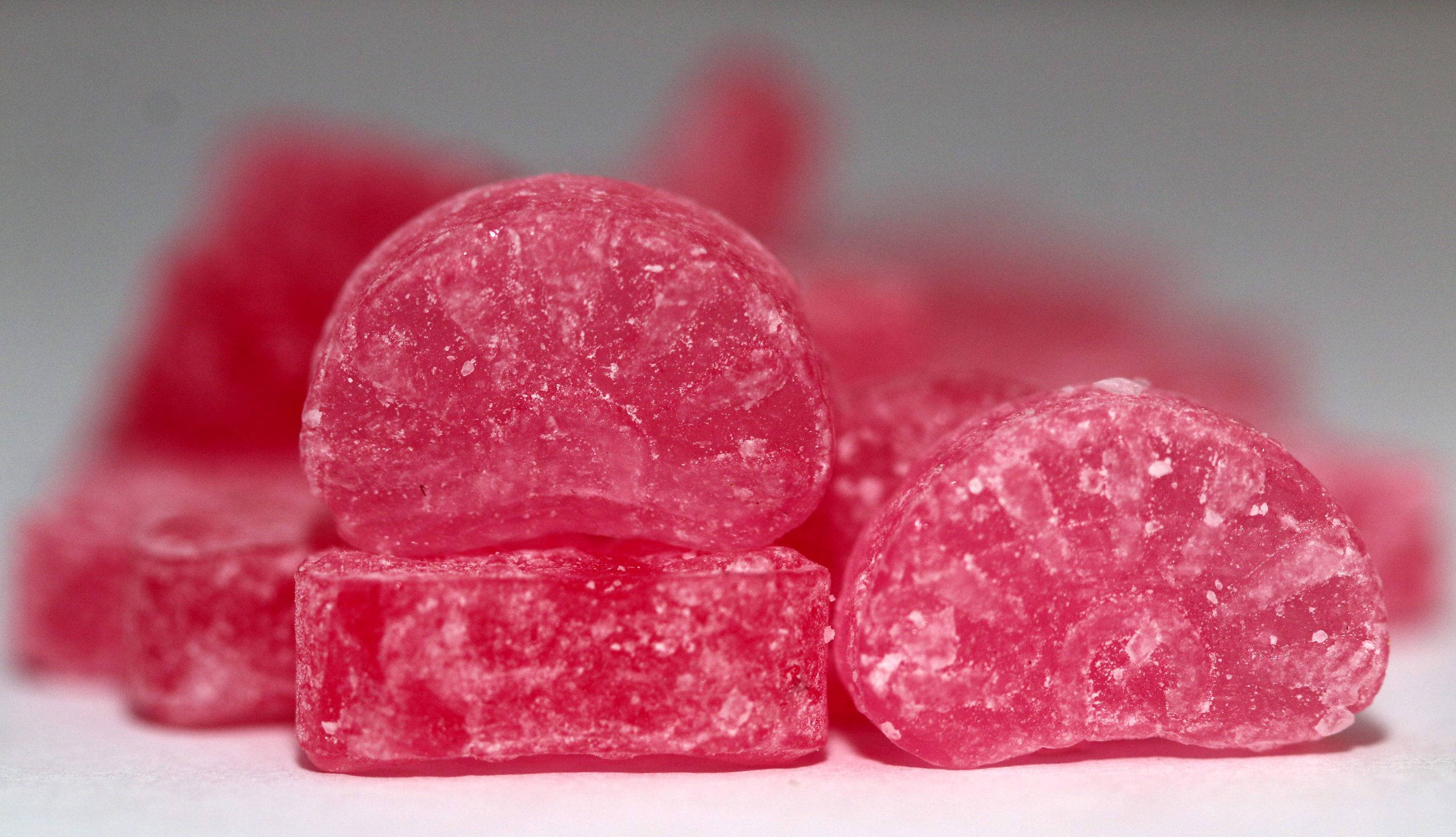 pink chewy candy, glossy pink sugar-coated candies, crystalline texture, 2K Desktop Wallpaper