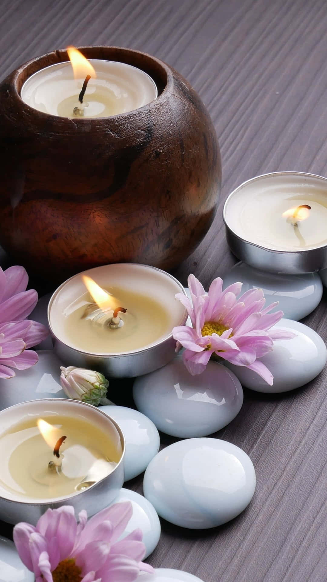 Pink Chrysanthemums, wooden surface, lit candles, Full HD Phone Wallpaper