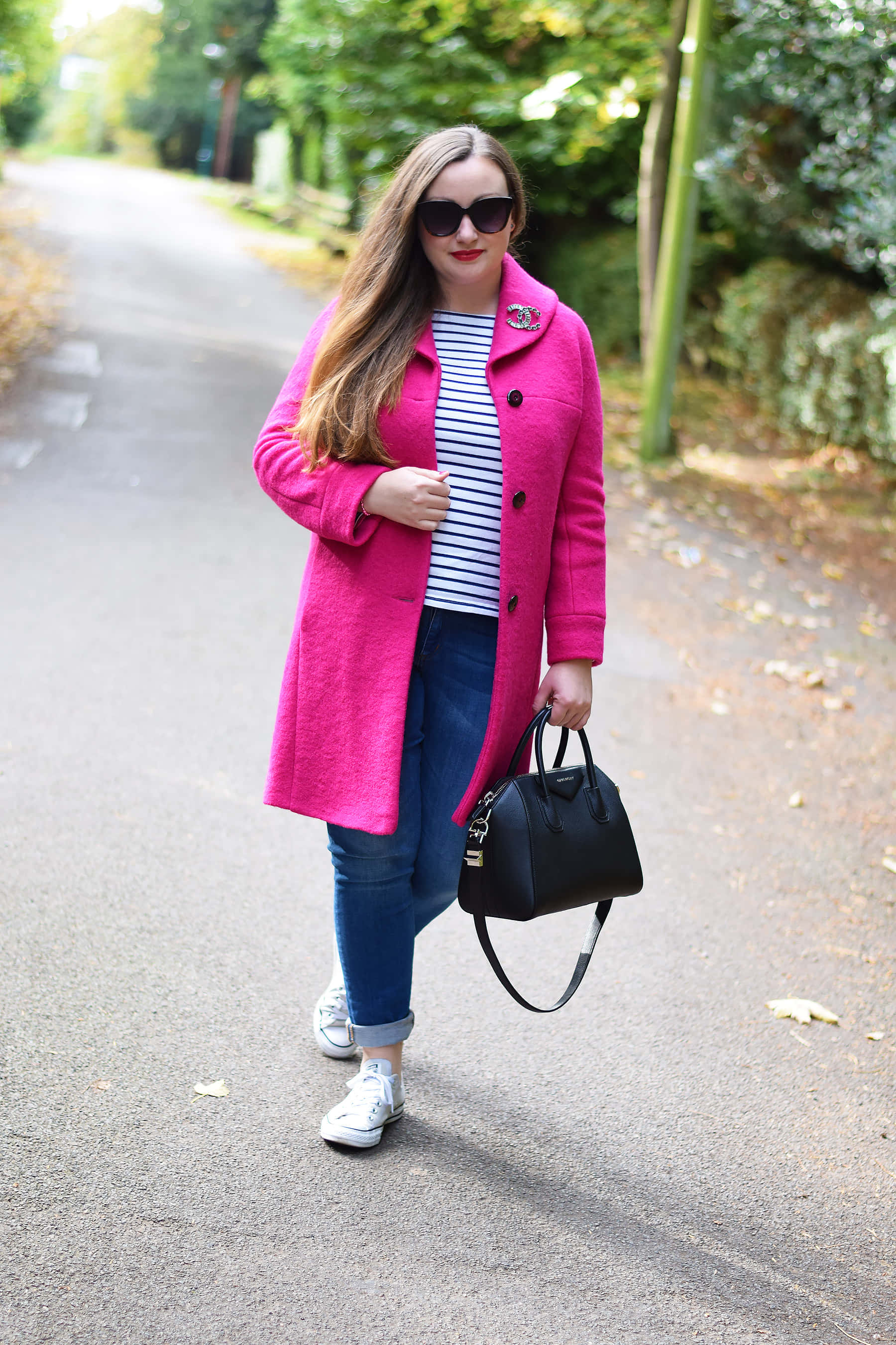 vibrant pink coat, striped shirt, tree-lined autumn path, 2K Phone Wallpaper