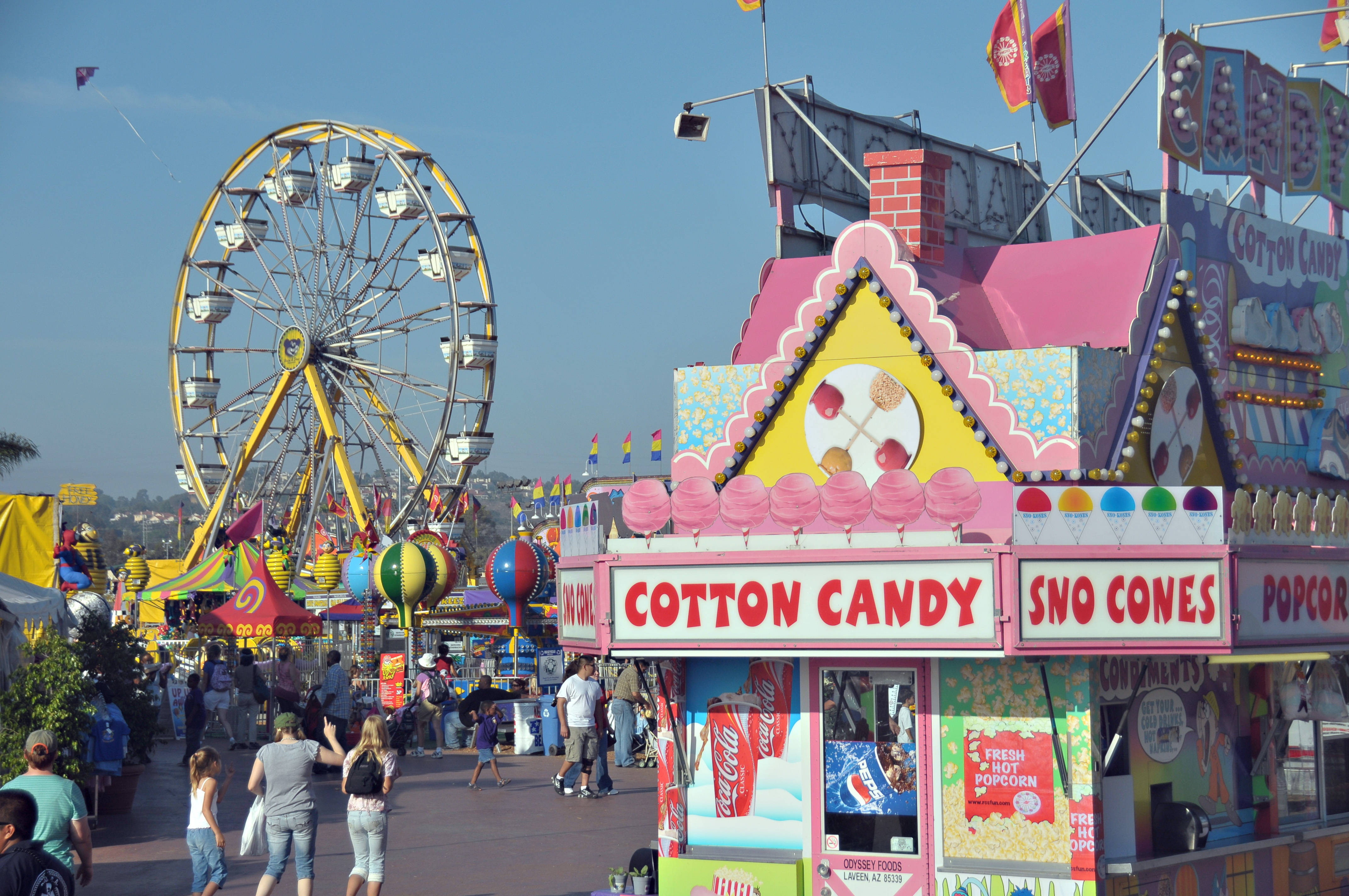 cotton candy stand, vibrant carnival scene, towering yellow Ferris wheel, 4K Desktop Wallpaper