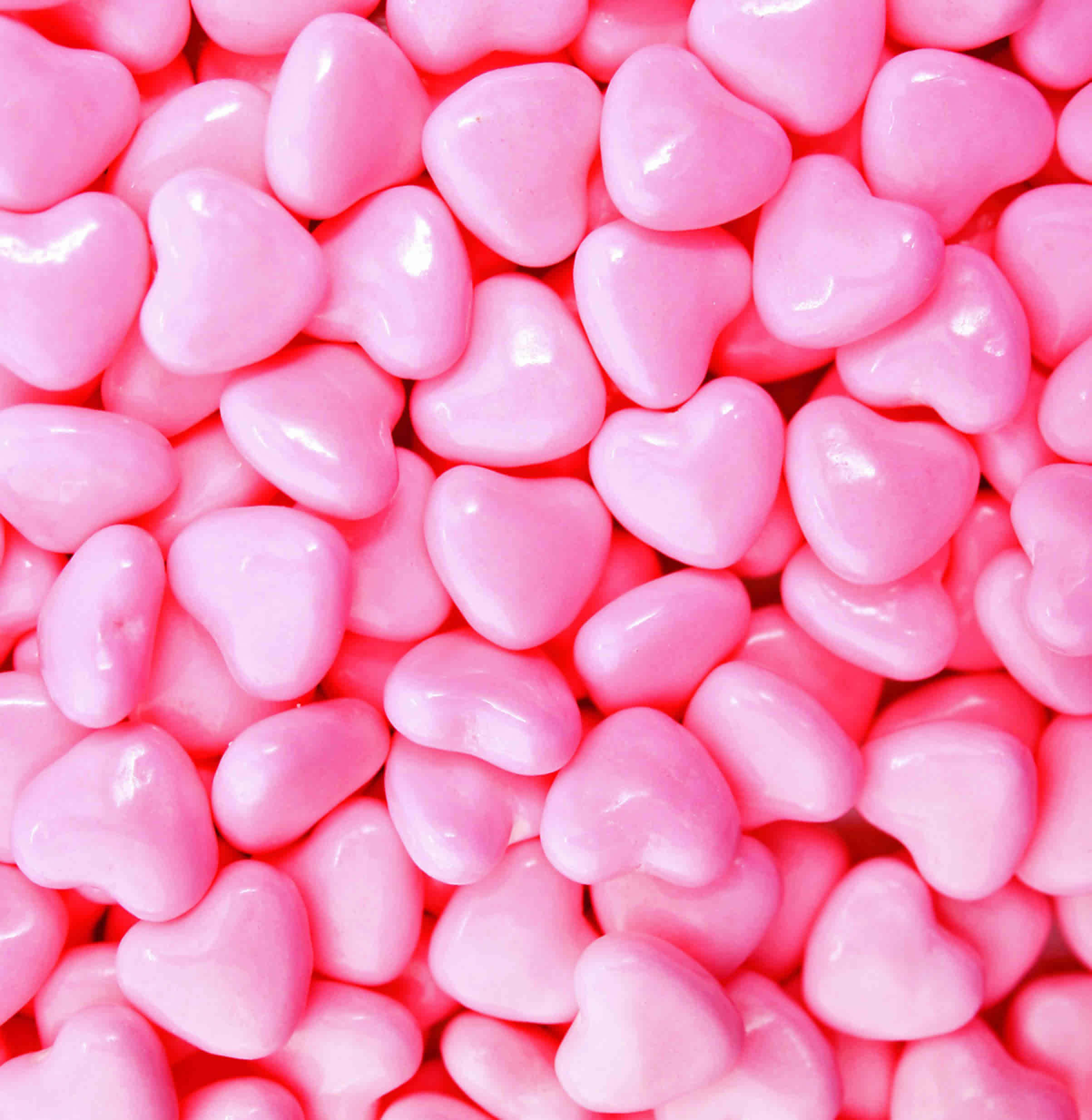 Decadent Pink Candy Delight, glossy pink heart-shaped candies, soft light reflections, Full HD Phone Wallpaper