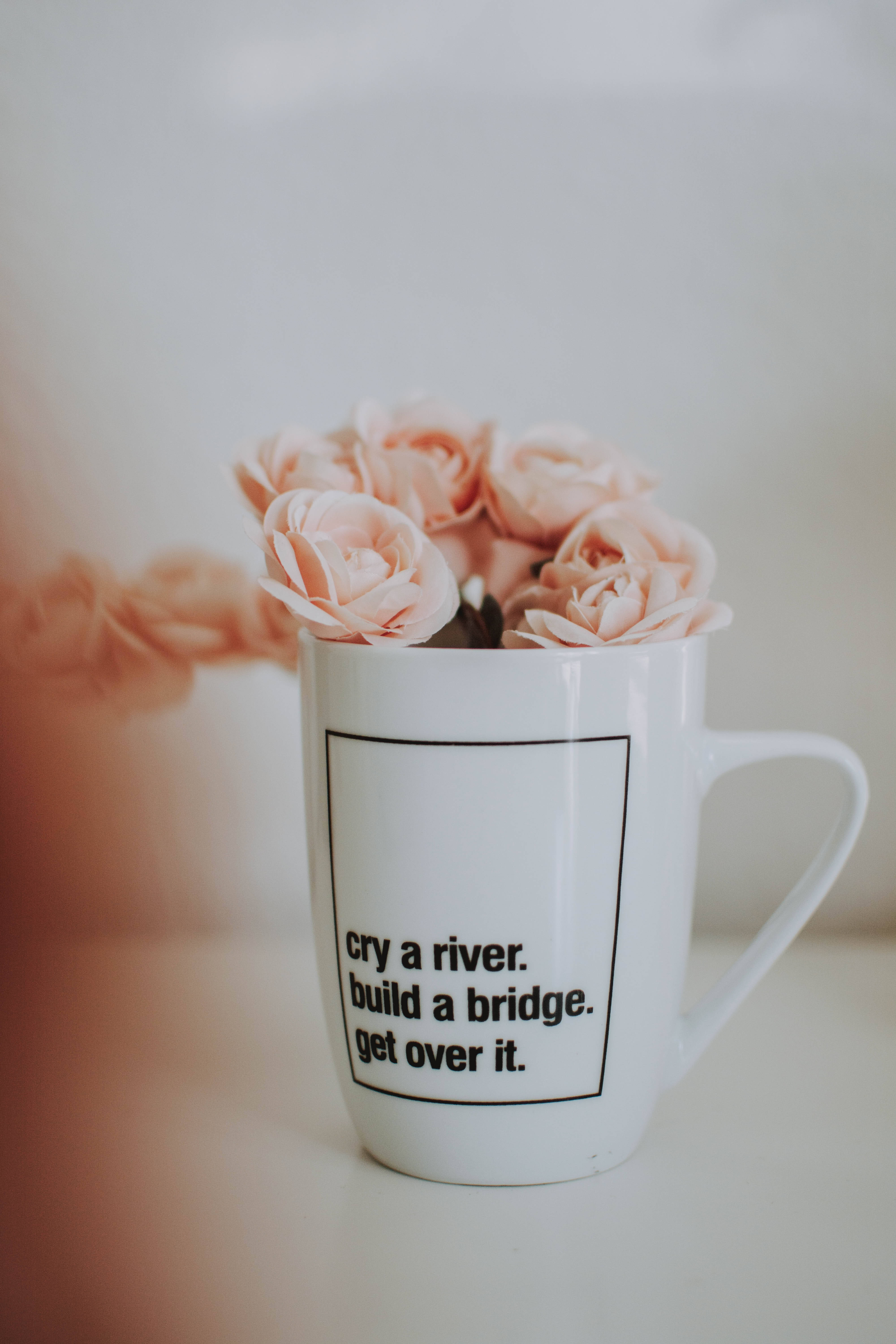 white mug, soft pink roses, blurred warm background, 5K Phone Wallpaper