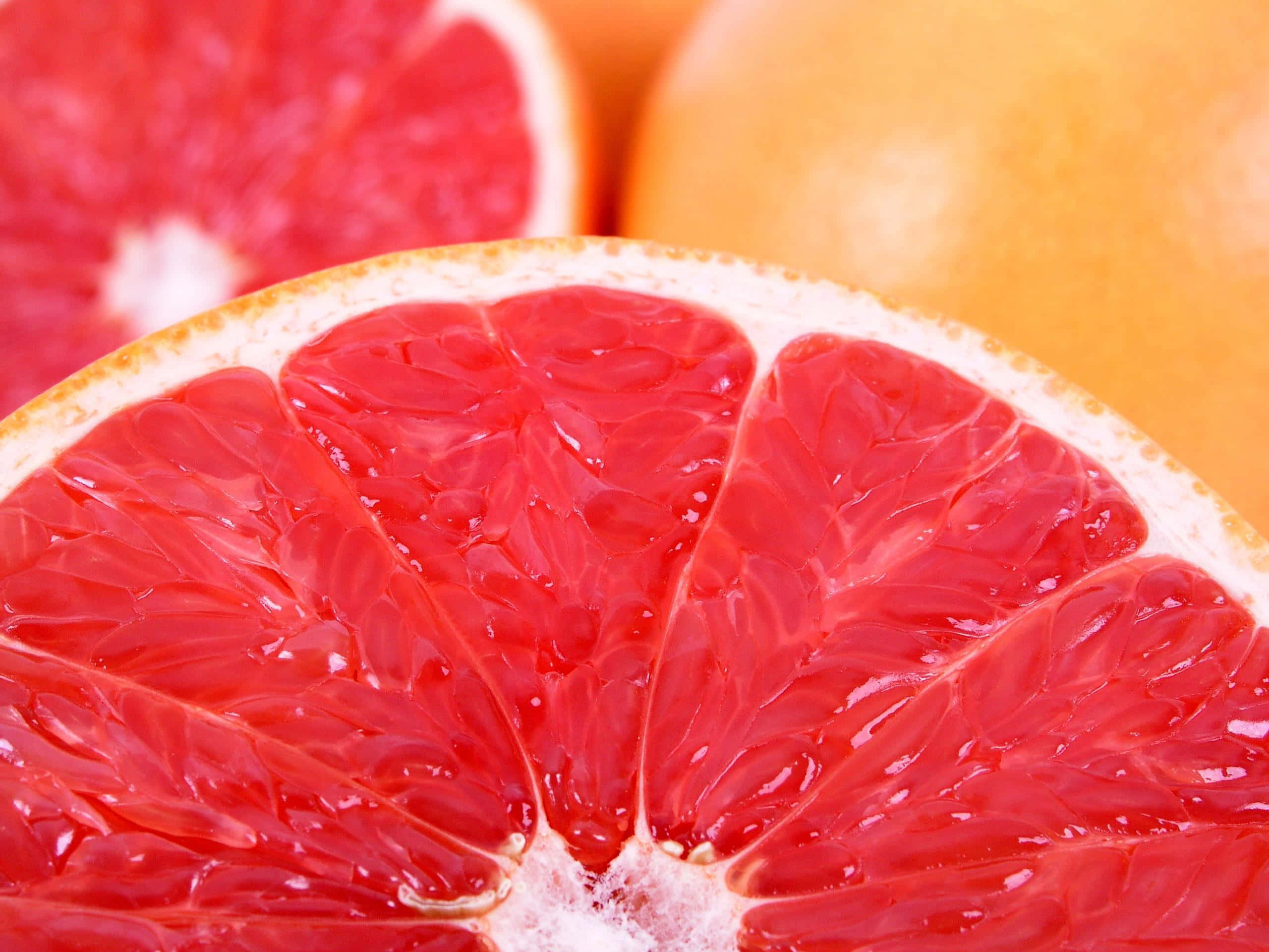 Pink Grapefruit, juicy red grapefruit slice, glistening pulp, 2K Desktop Wallpaper