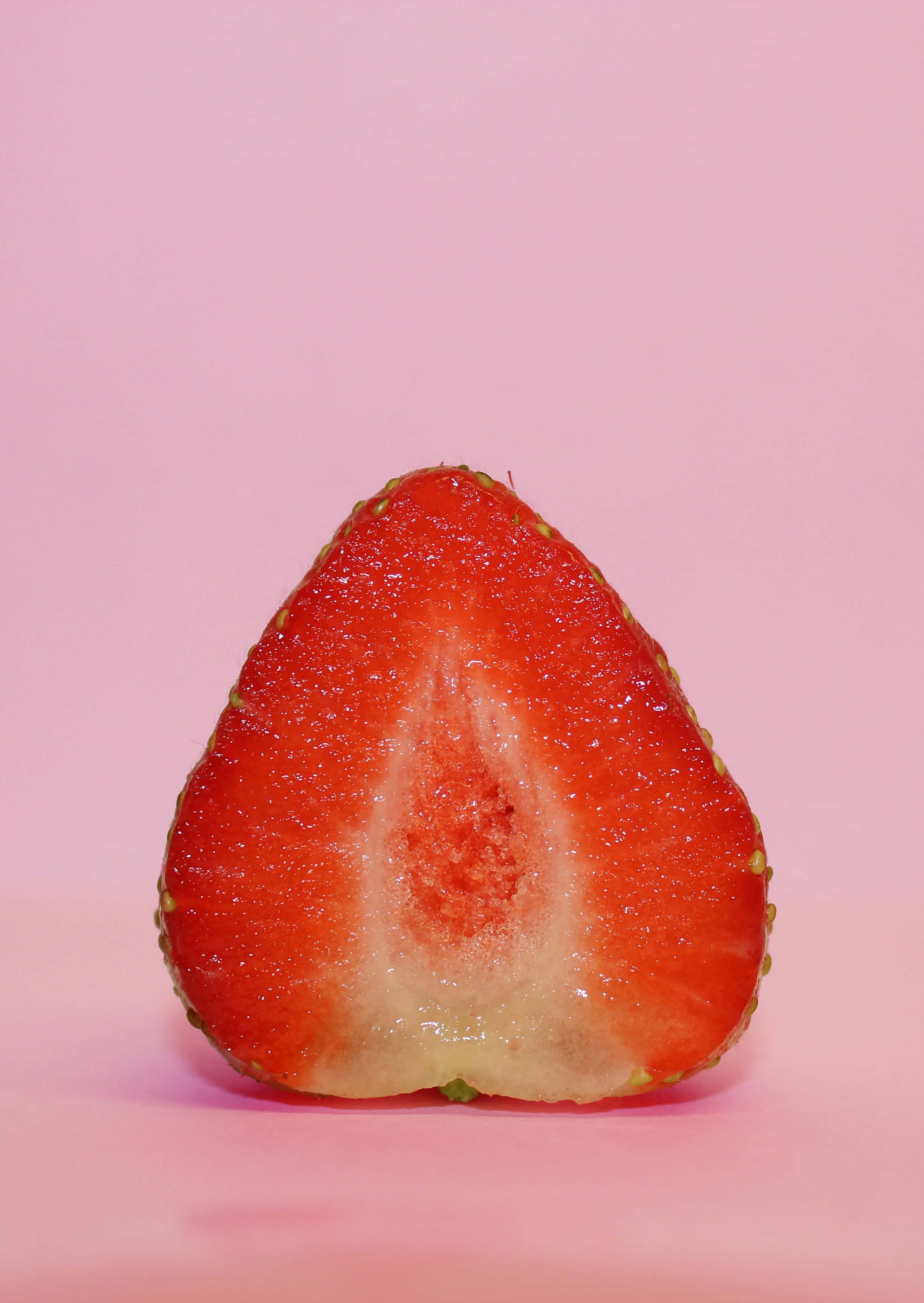 Pink Background Half Strawberry, strawberry, juicy red flesh, 2K Phone Wallpaper
