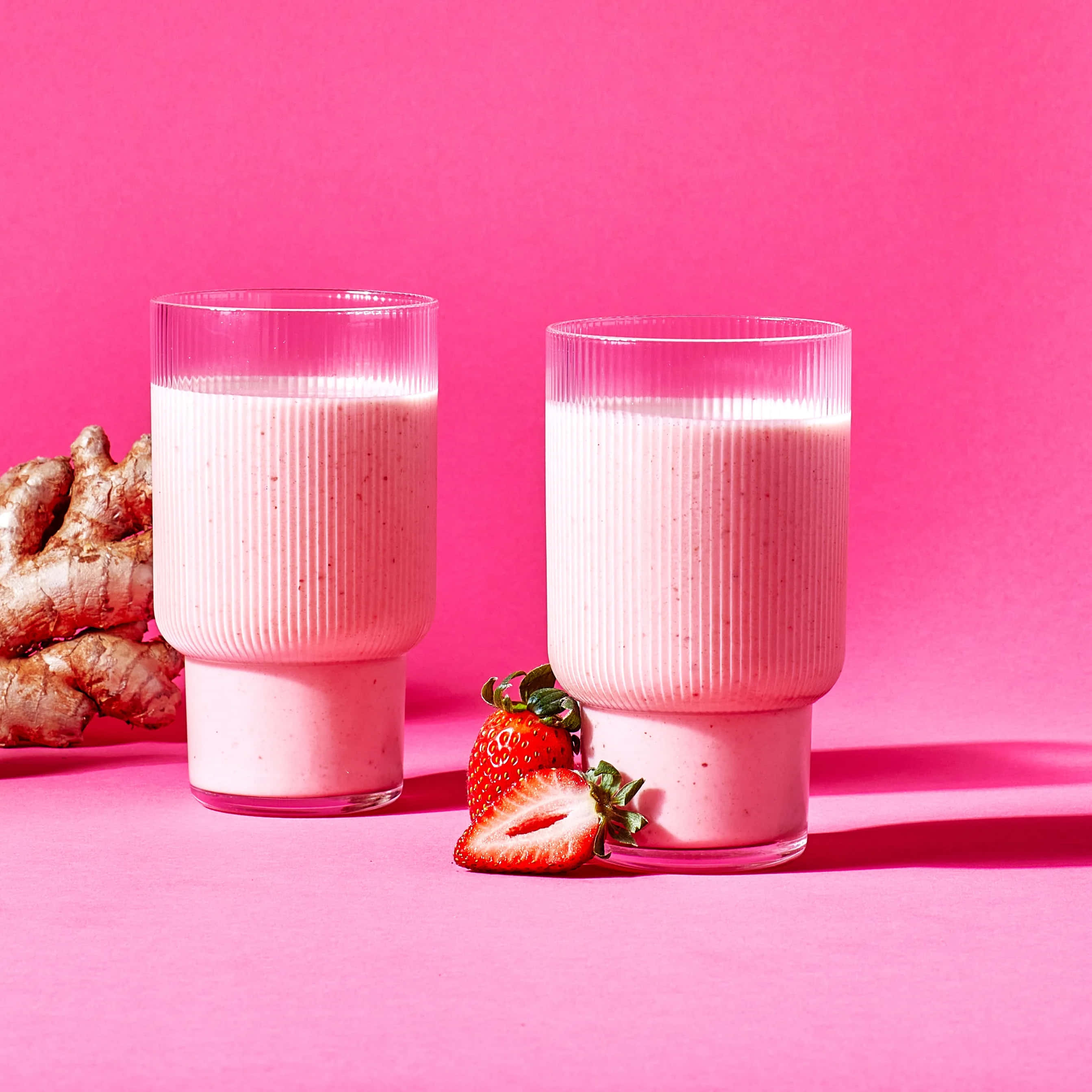 pink strawberry smoothie, vibrant pink background, fresh strawberries, 2K Desktop Wallpaper