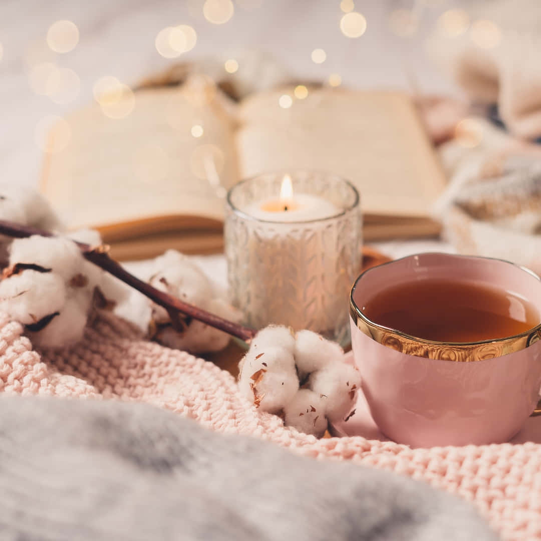 pink tea cup, gold rimmed hot beverage, lit candle, SD Desktop Wallpaper