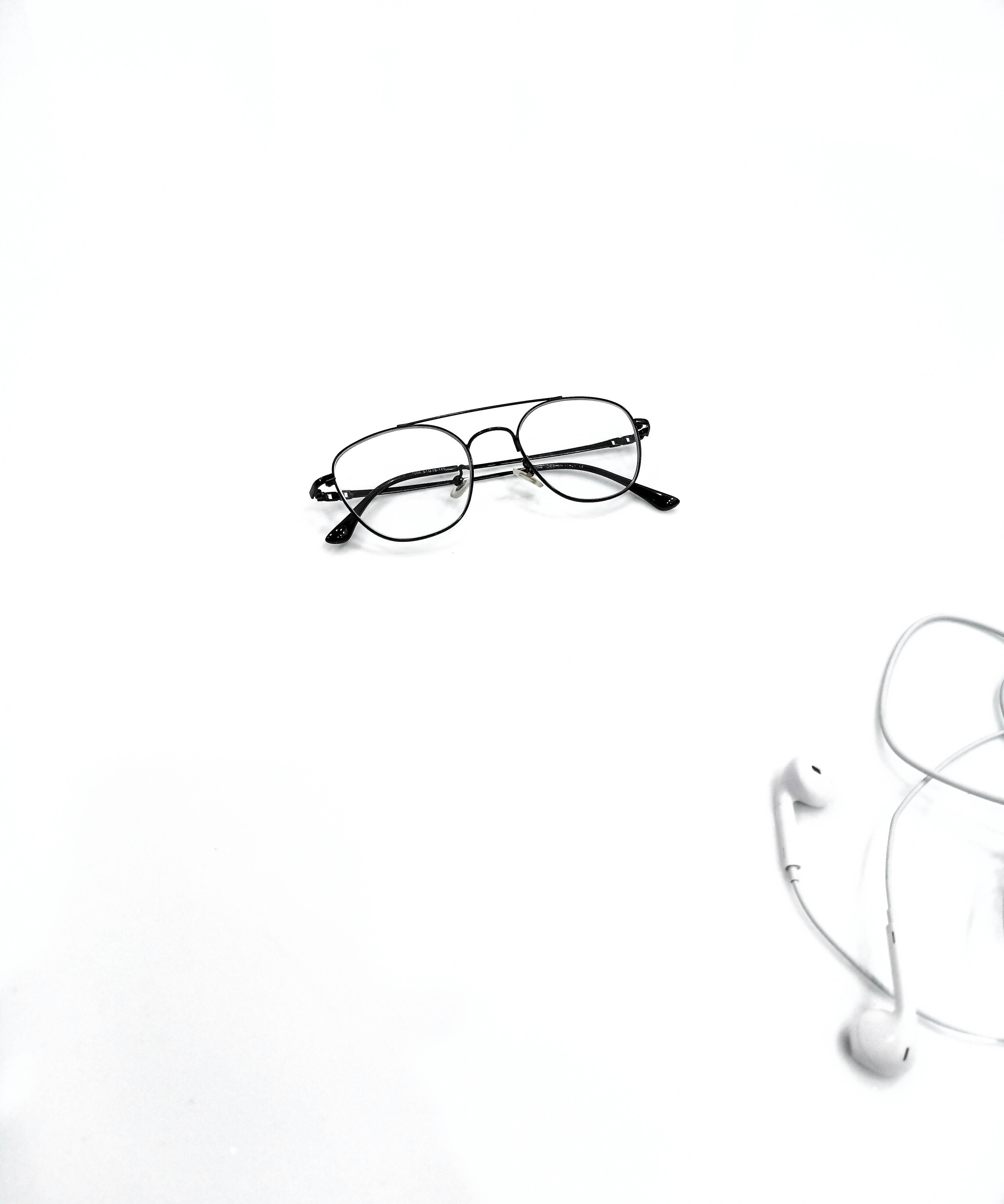 black-framed glasses, white earphones, stark white surface, 4K Phone Wallpaper