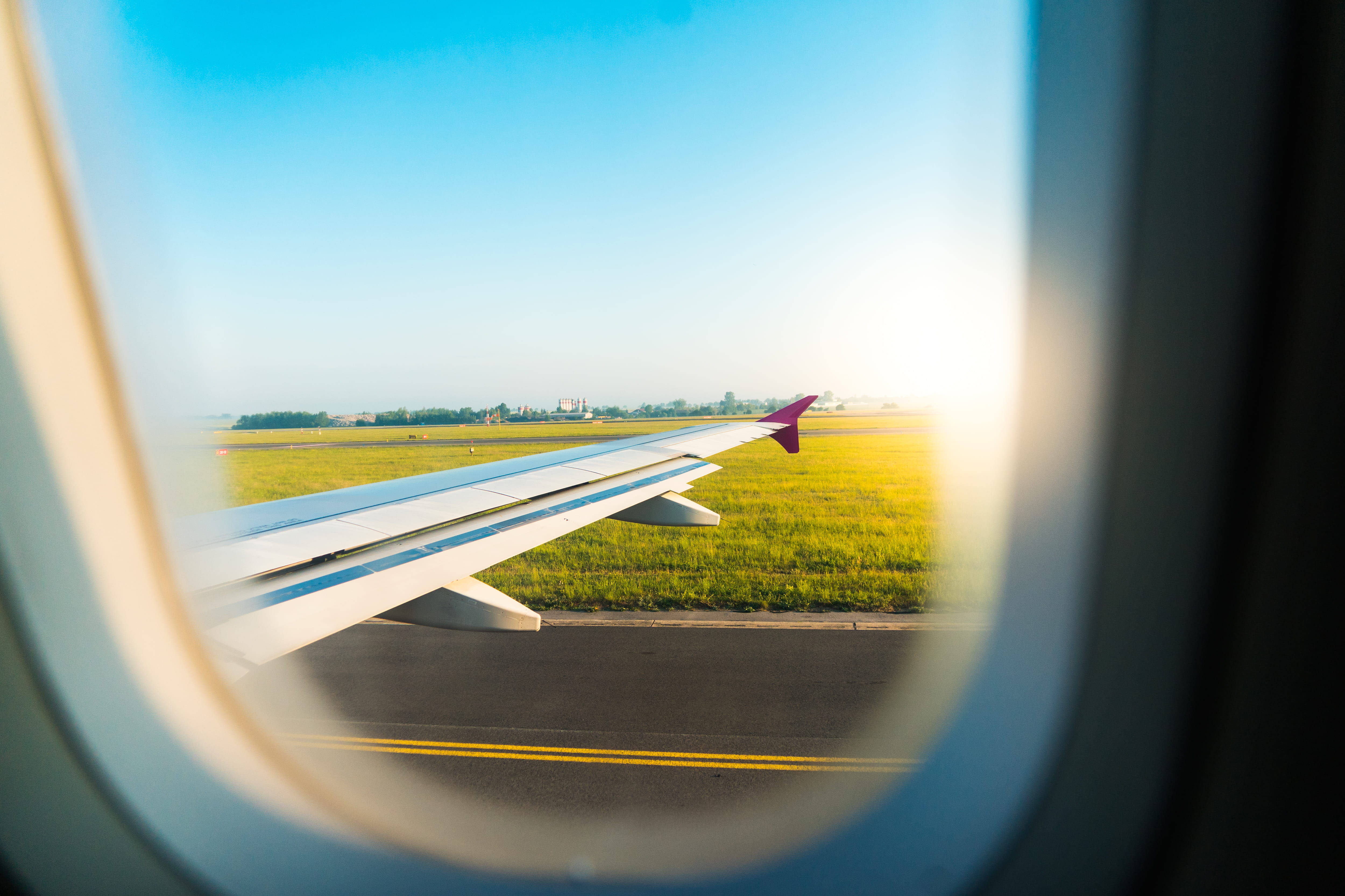 Aircraft wing, airplane window, sunlit runway, 4K Desktop Wallpaper
