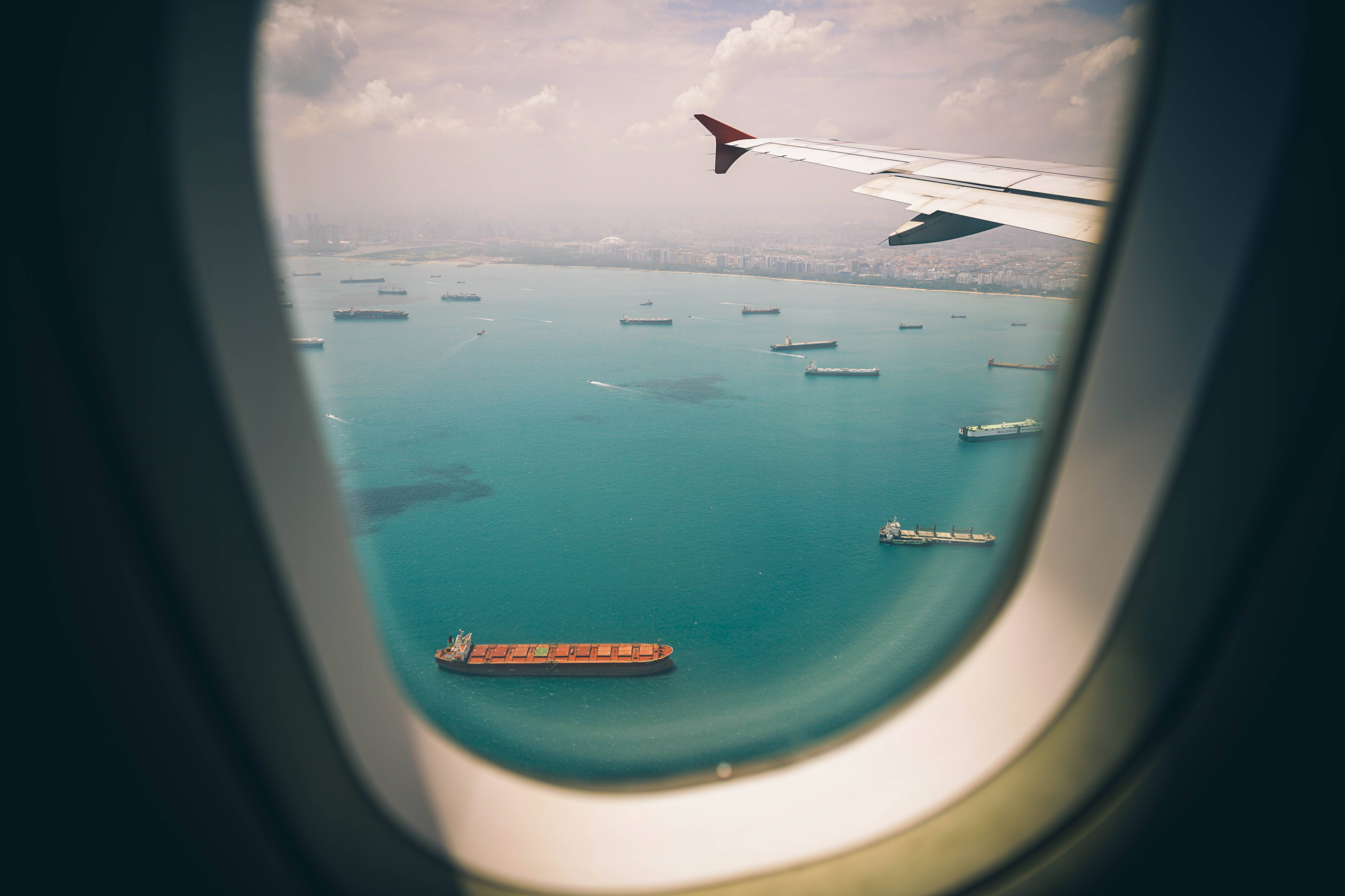 plane window, turquoise sea, cargo ships, 5K Desktop Wallpaper