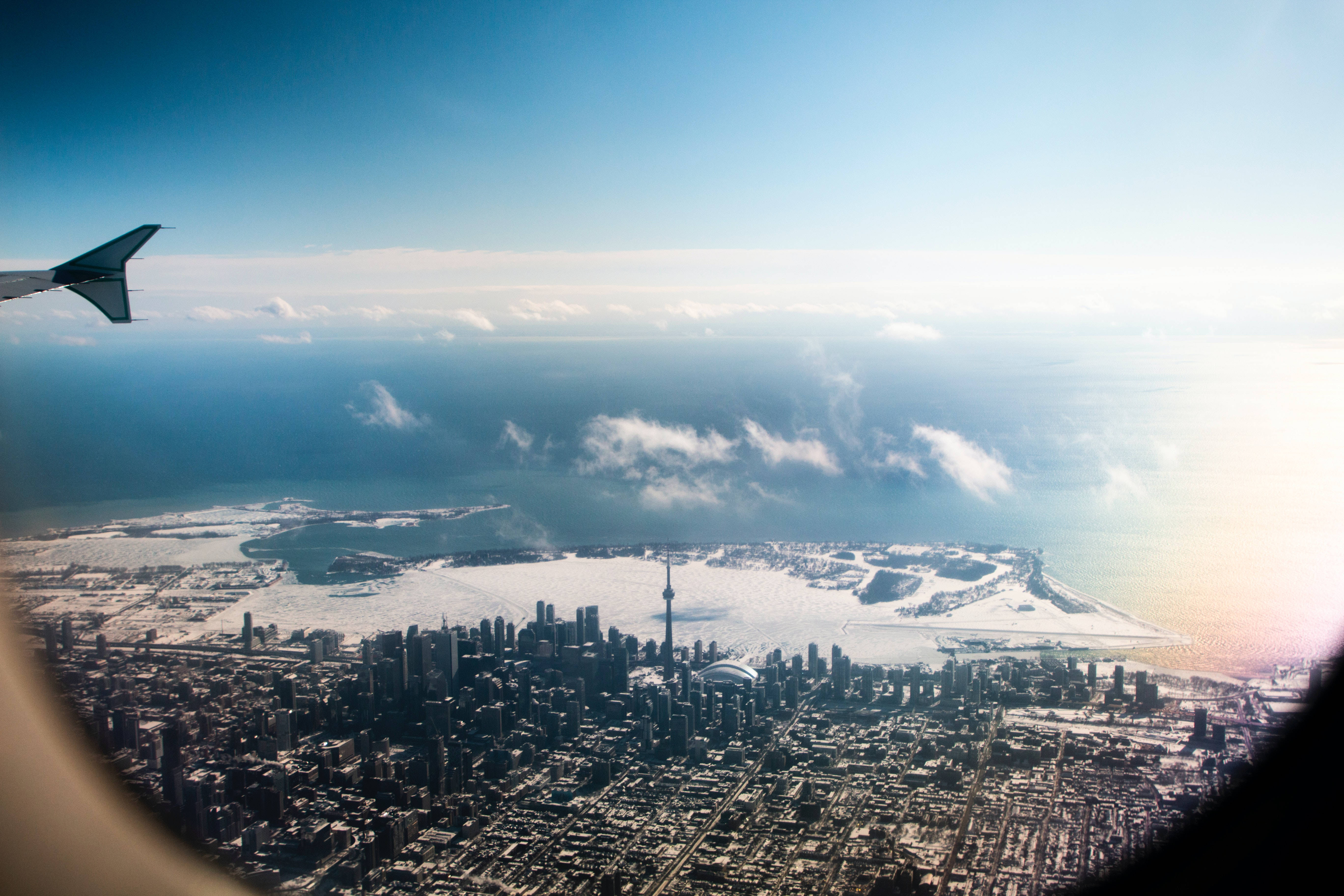 Toronto skyline, snowy waterfront, airplane window, 5K Desktop Wallpaper