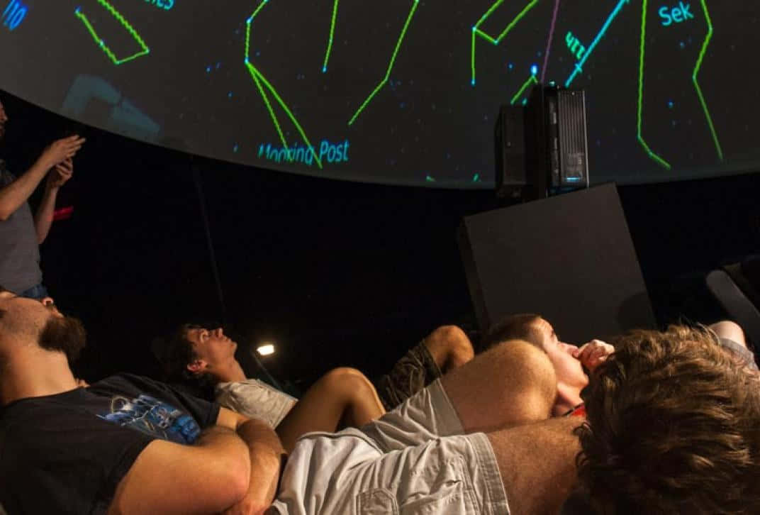 Planetarium, curved screen, glowing green constellations, SD Desktop Wallpaper