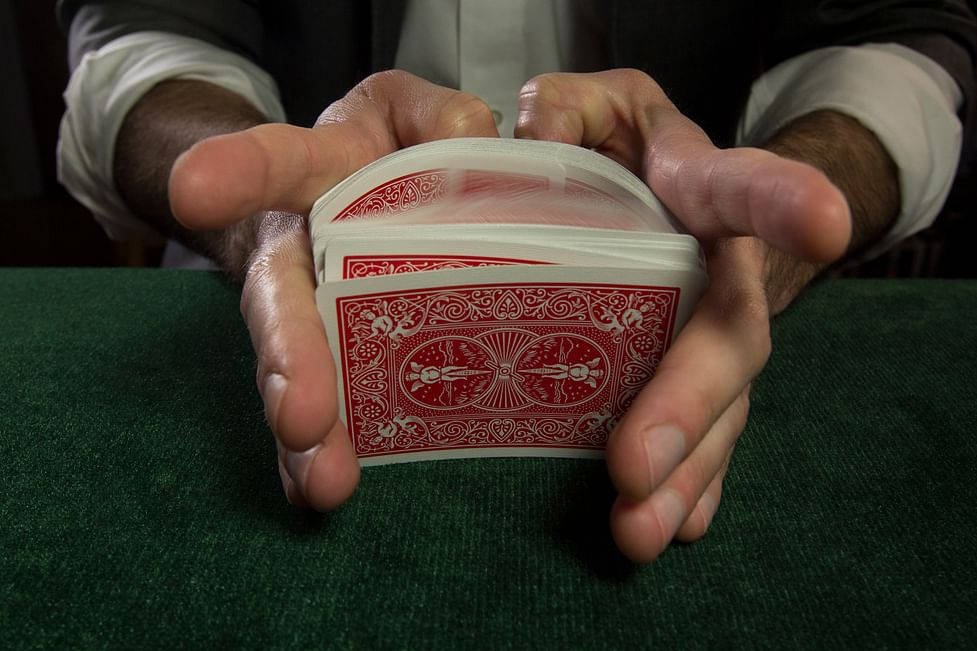 red-backed playing cards, green felt surface, hands, SD Desktop Wallpaper