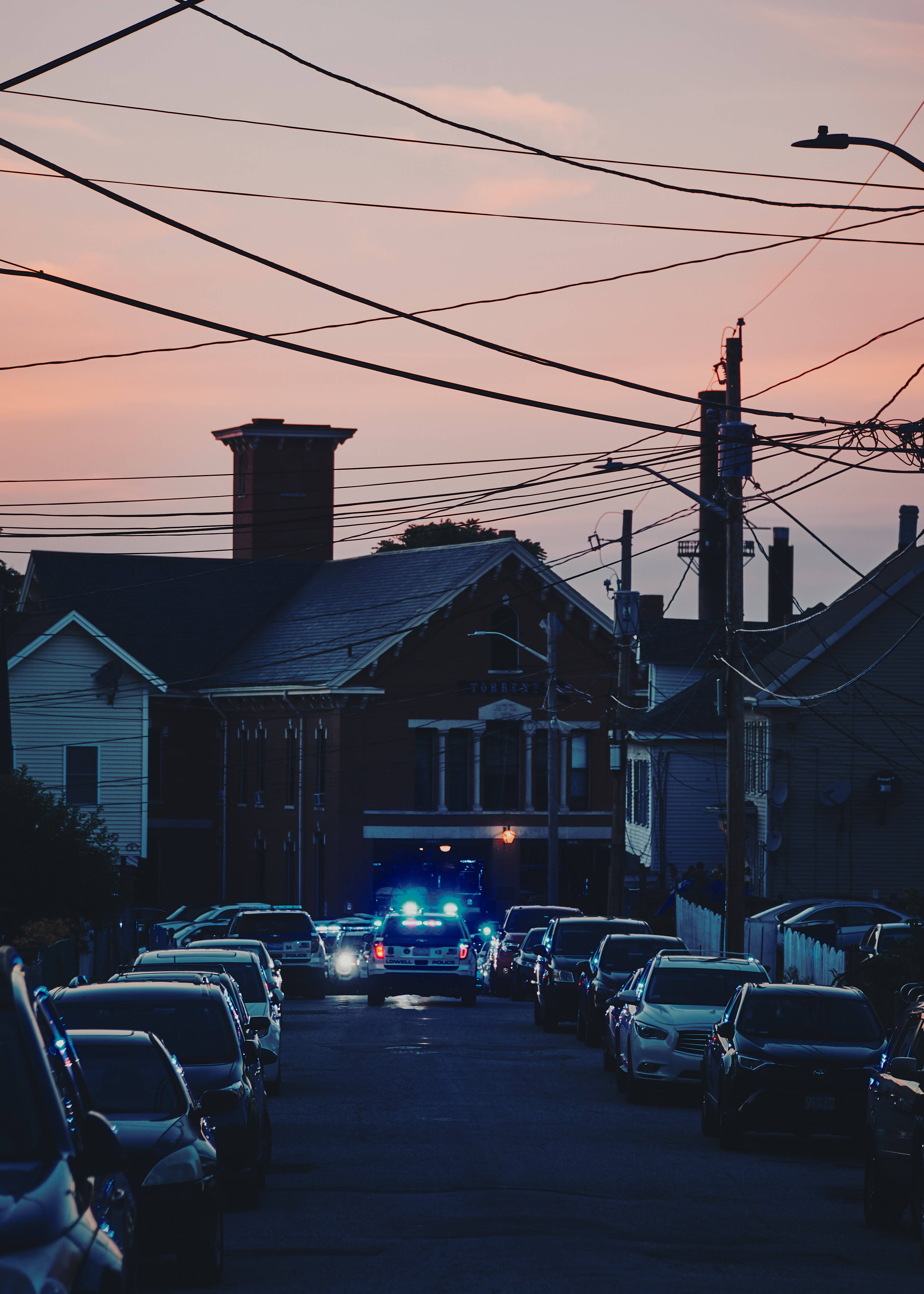 police car, flashing blue lights, narrow residential street, 4K Phone Wallpaper