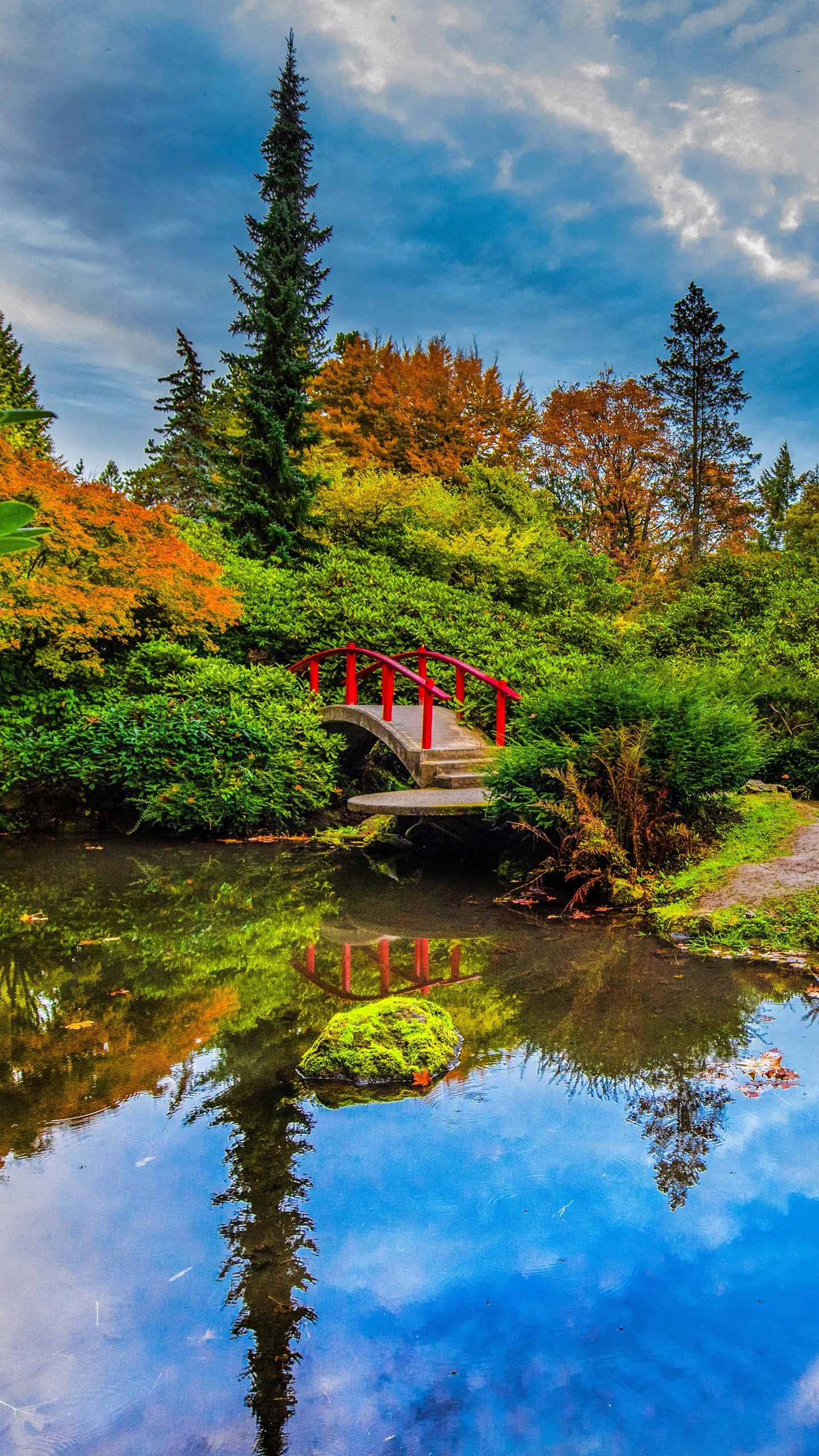 vibrant red arched bridge, calm pond, autumn trees, 2K Phone Wallpaper