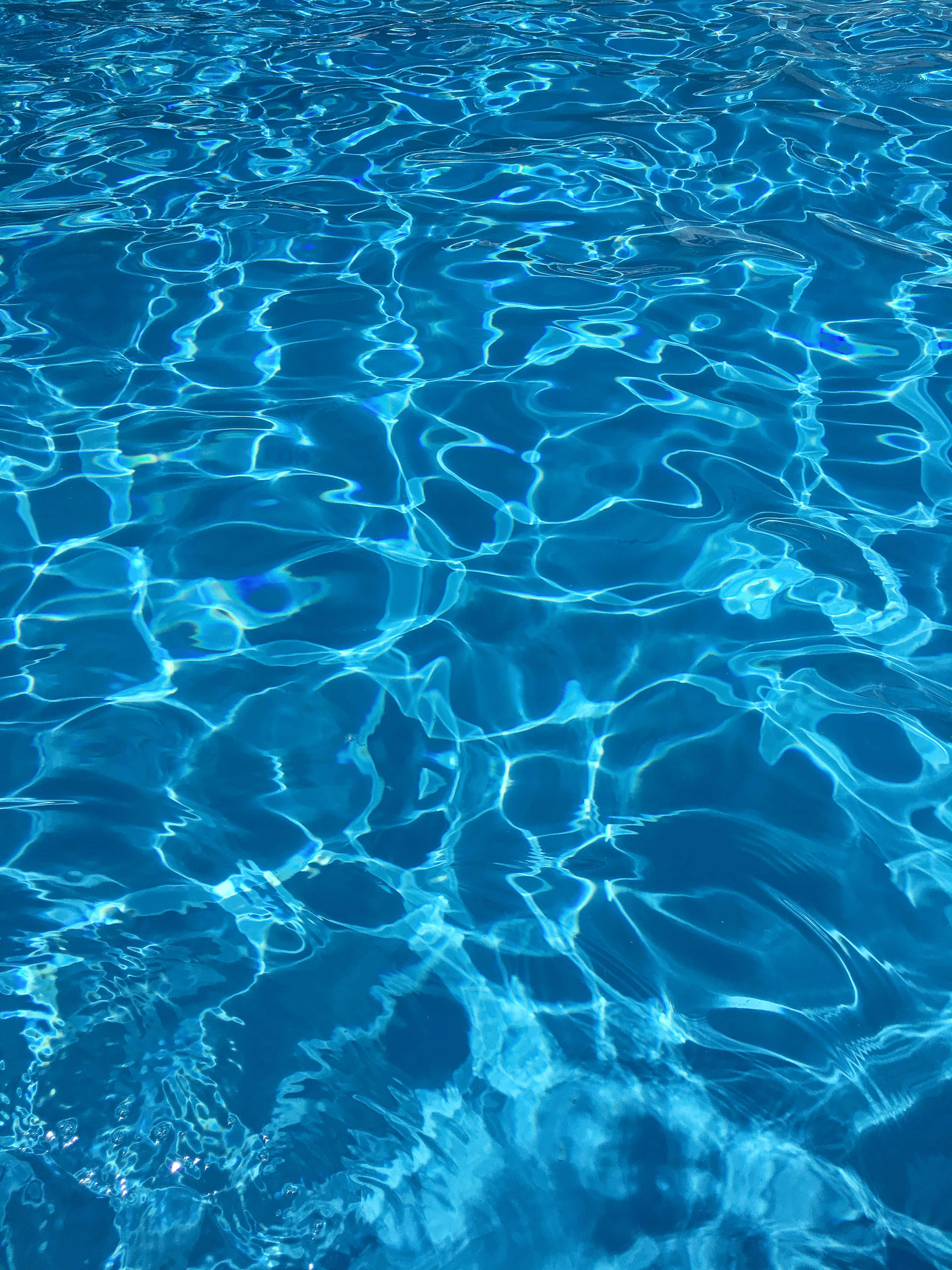 dark blue pool water, sunlight, rippling surface, 4K Phone Wallpaper