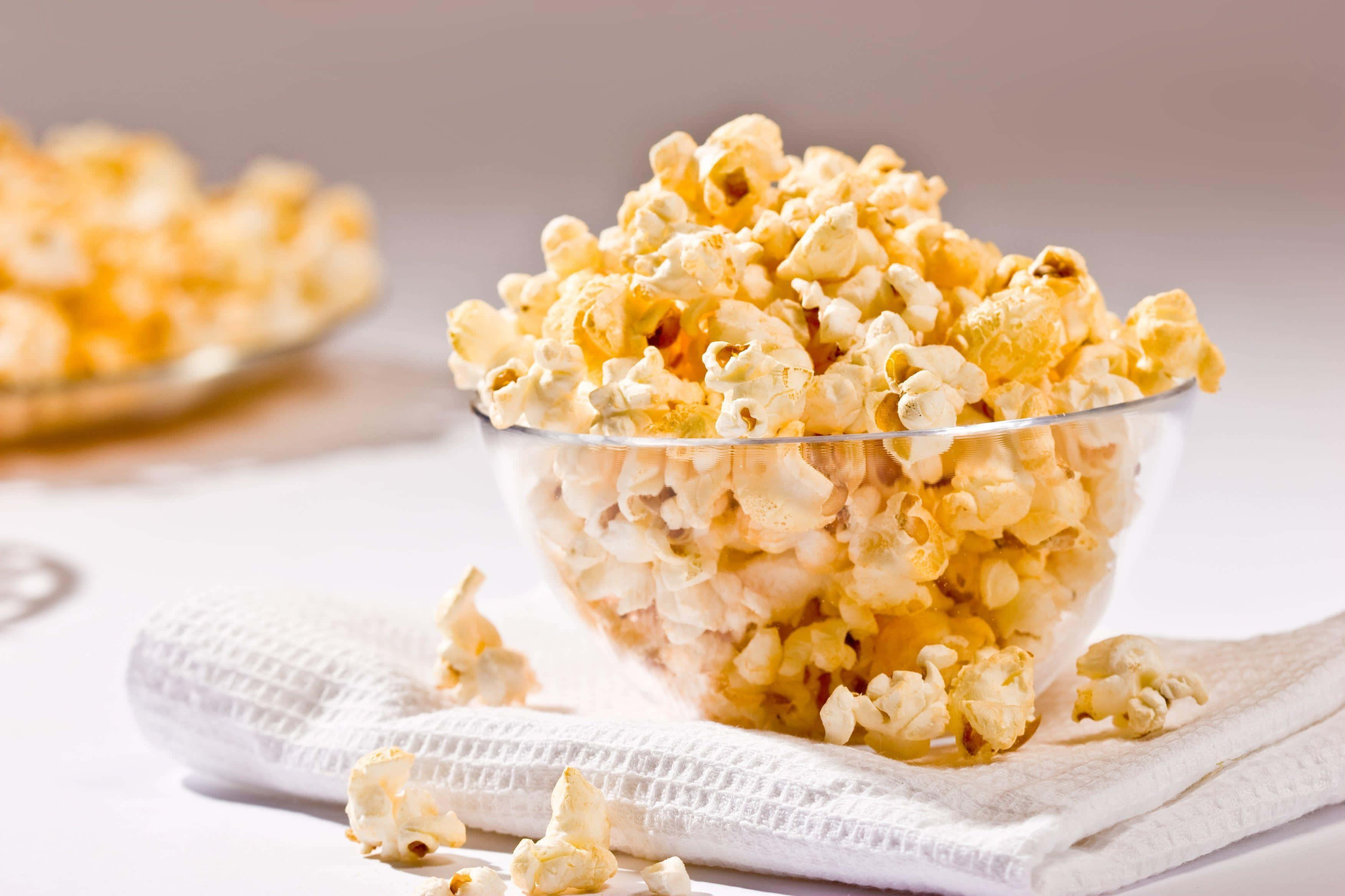bowlof fresh popcorn, clear glass bowl, golden buttery popcorn, 2K Desktop Wallpaper