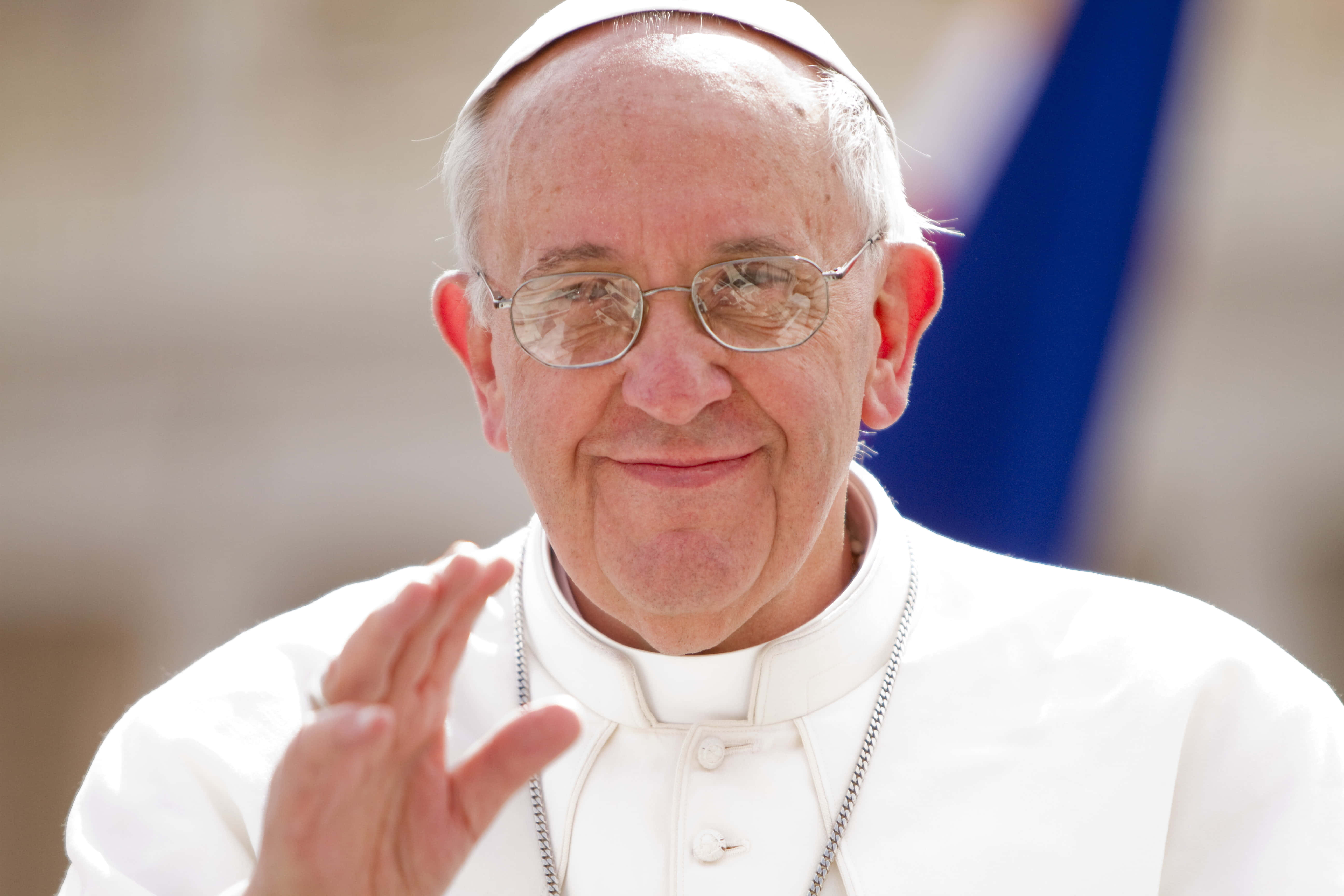 Pope Francis, bright outdoor setting, blurred blue flag, 5K Desktop Wallpaper