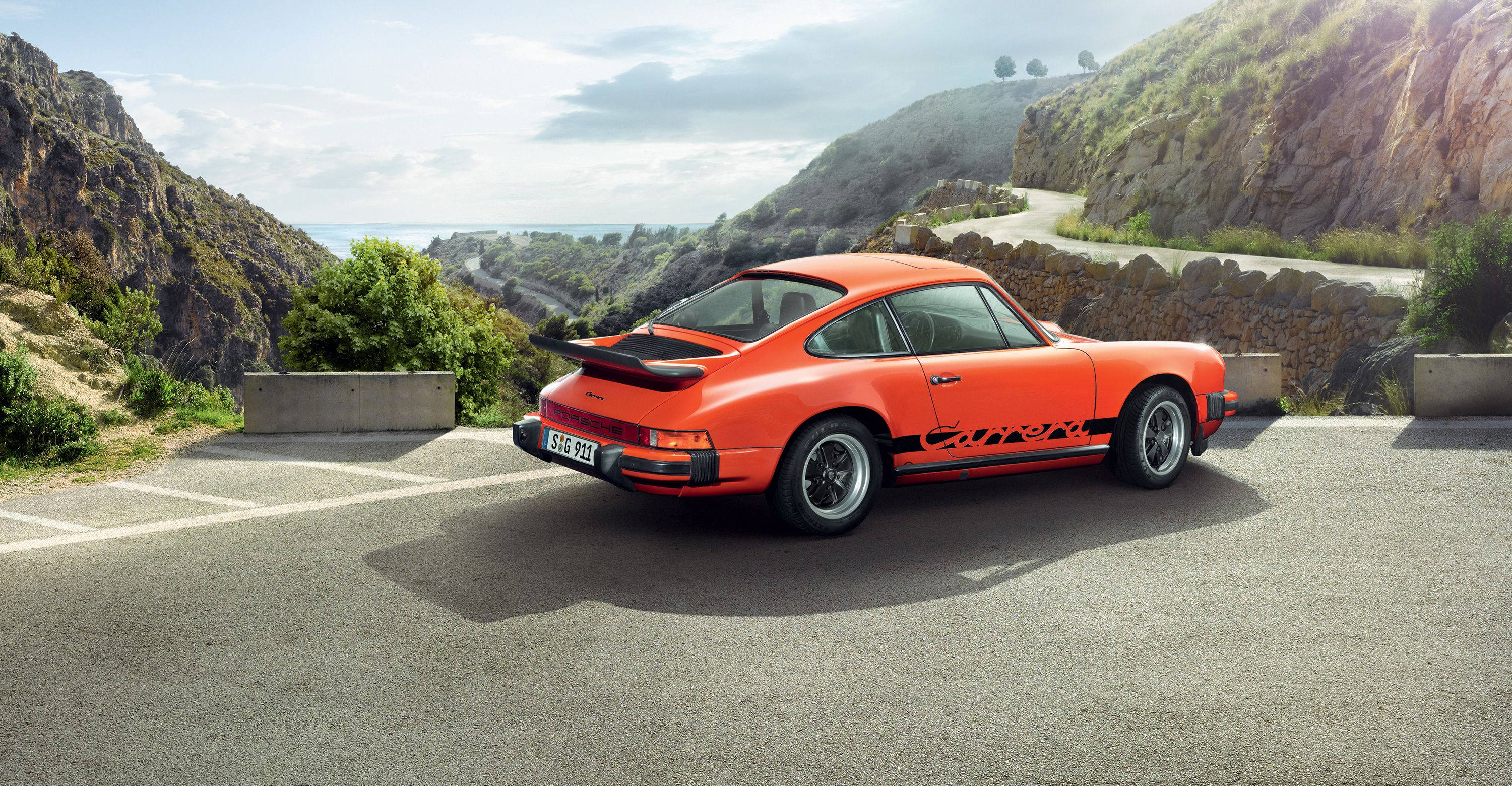Porsche 911, tangerine paint, coastal cliffside road, 2K Desktop Wallpaper