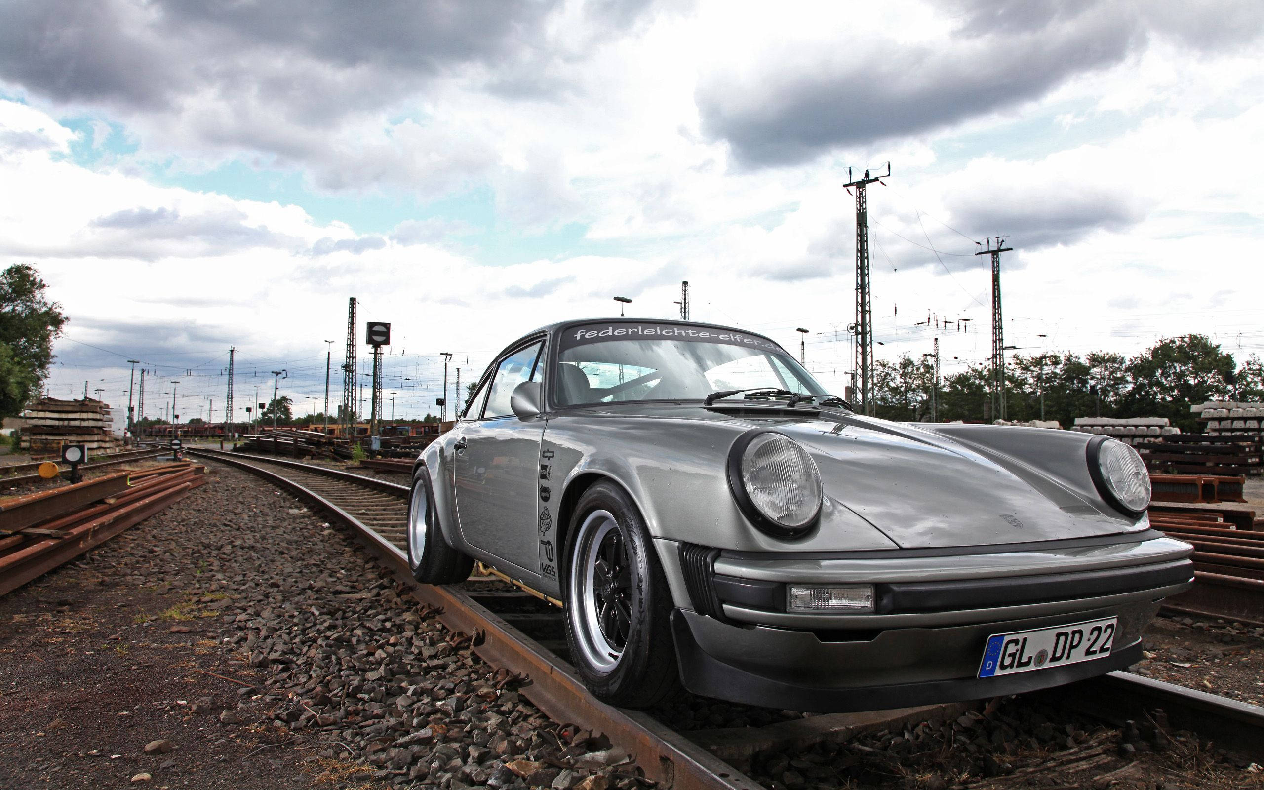 Porsche 911, train tracks, cloudy sky, 2K Desktop Wallpaper