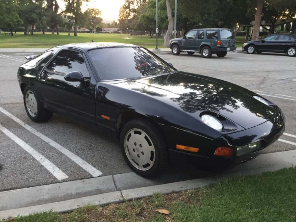 Porsche 928, sleek black, sunlit lot, SD Desktop Wallpaper