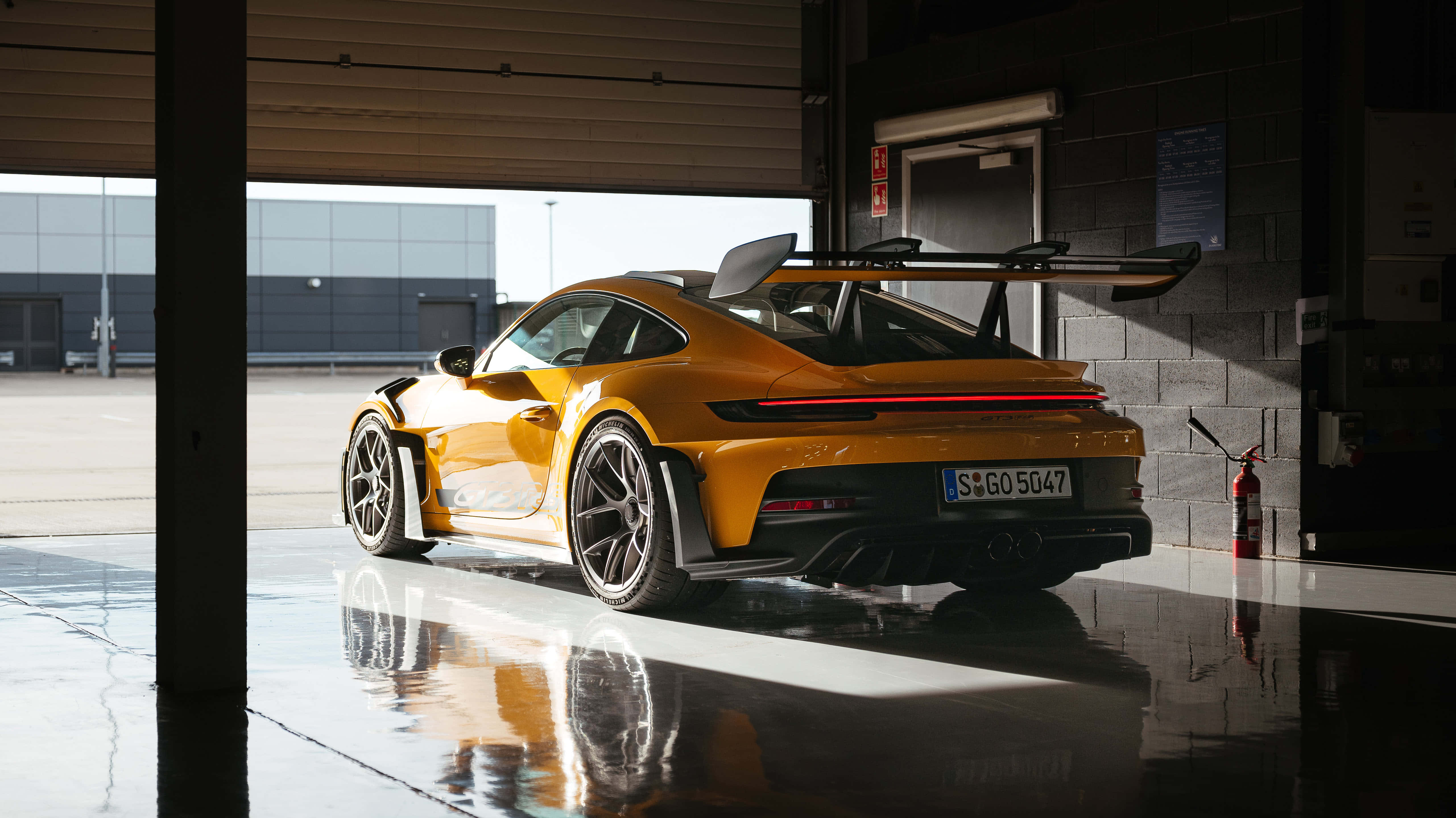 Porsche 911 GT3 RS, vibrant orange, sleek garage, 5K Desktop Wallpaper