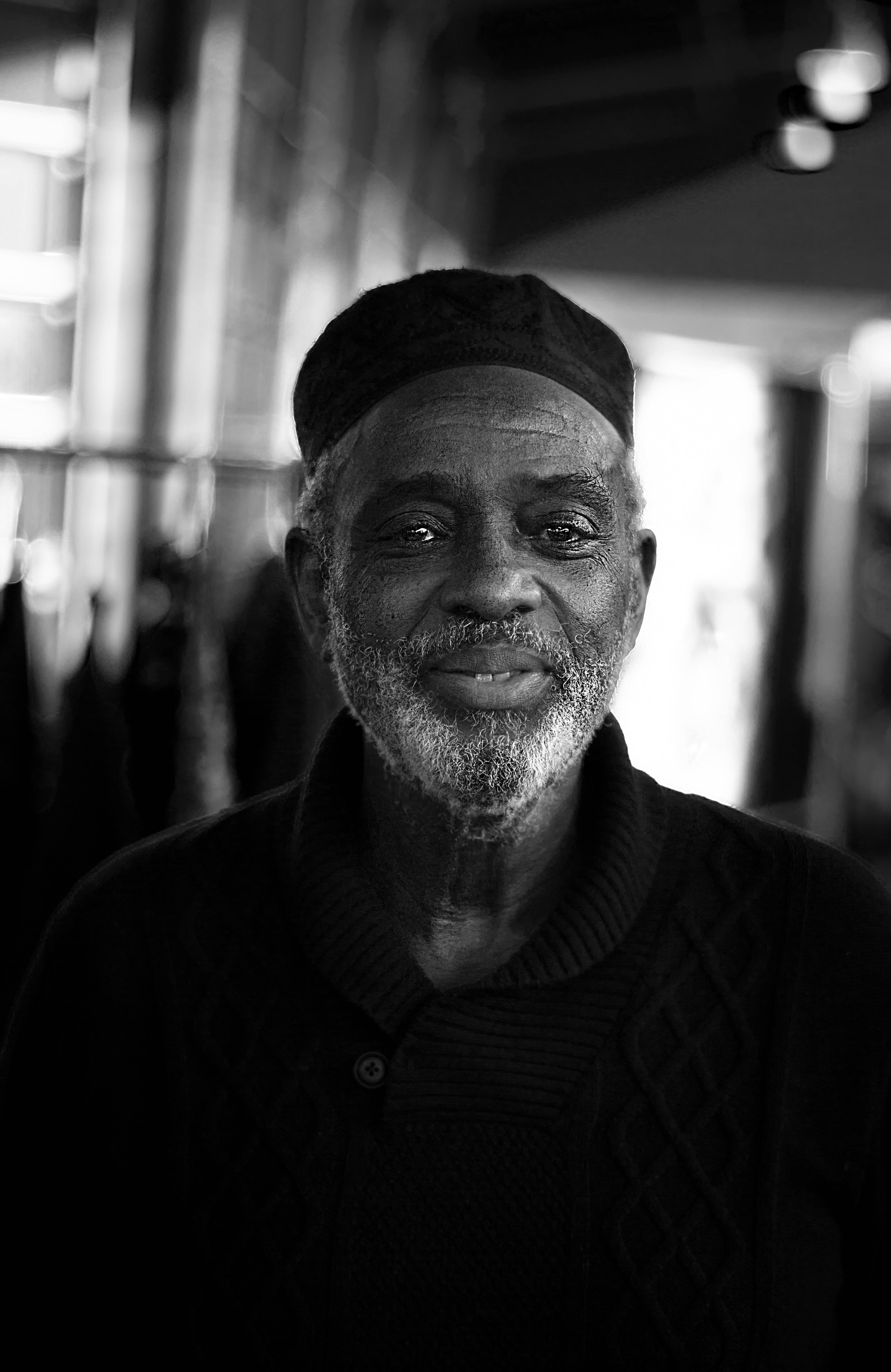old african man, black kufi hat, gentle smile, 5K Phone Wallpaper