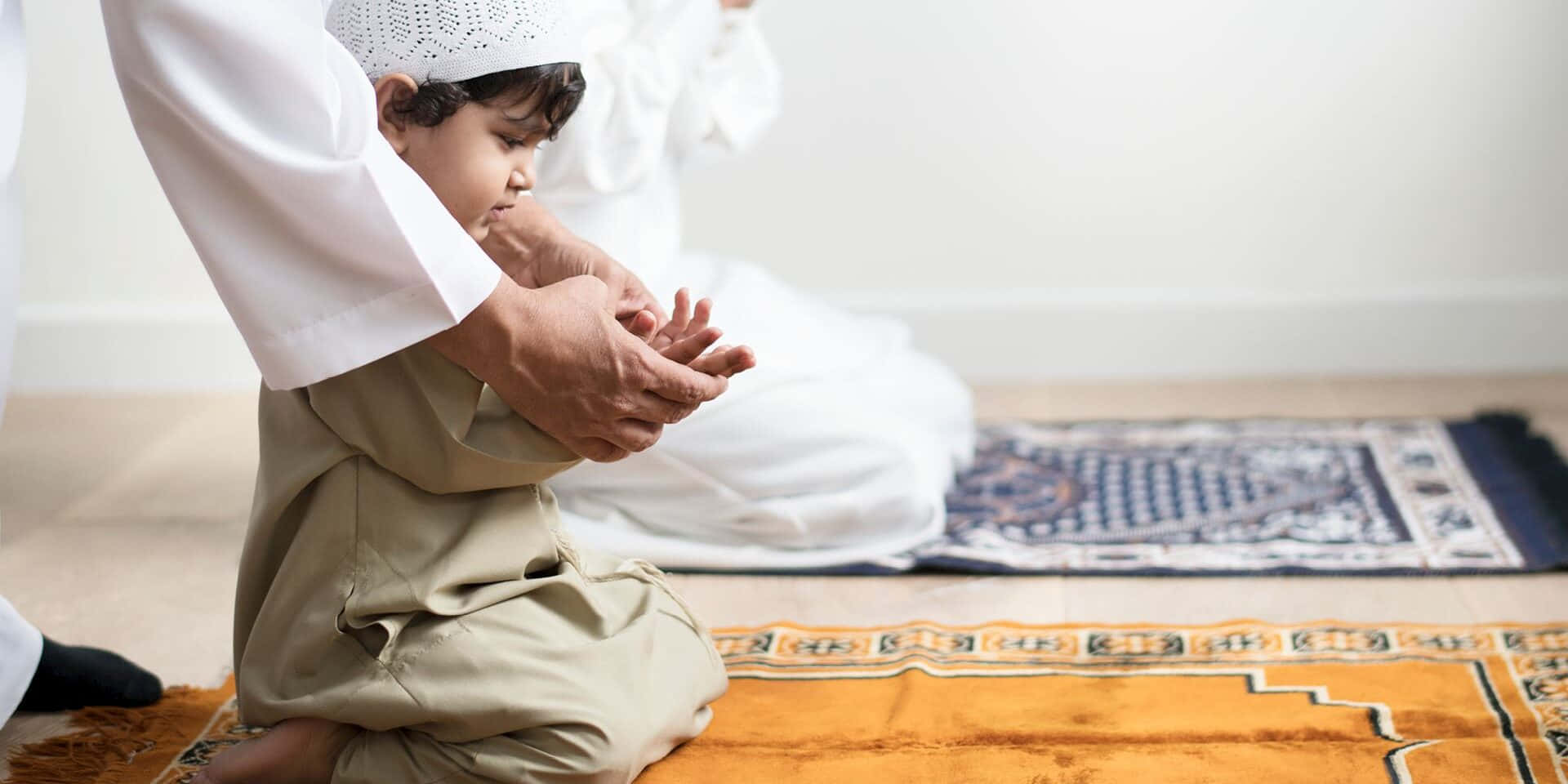 Muslim boy baby, traditional Islamic attire, kneels in prayer, Full HD Desktop Wallpaper