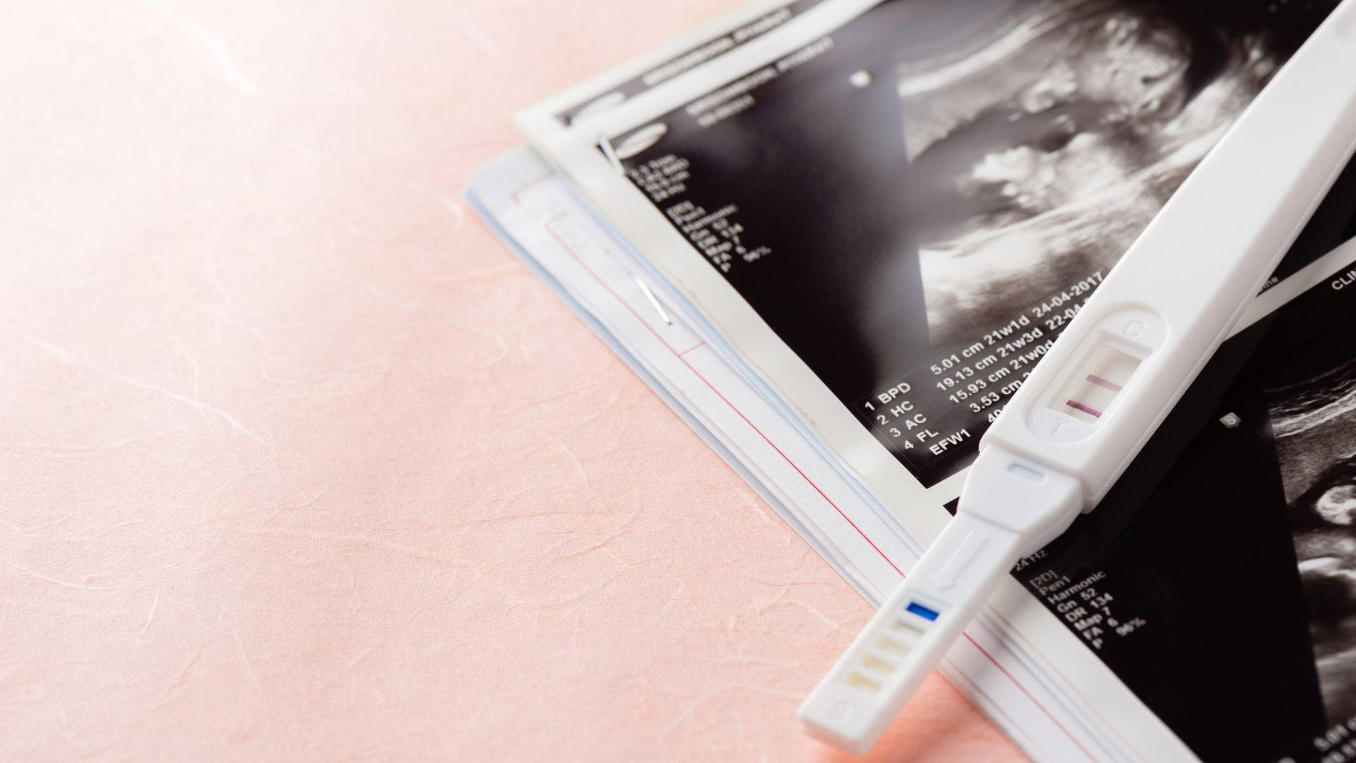 pregnancy test kit, ultrasound images, soft pink surface, Full HD Desktop Wallpaper