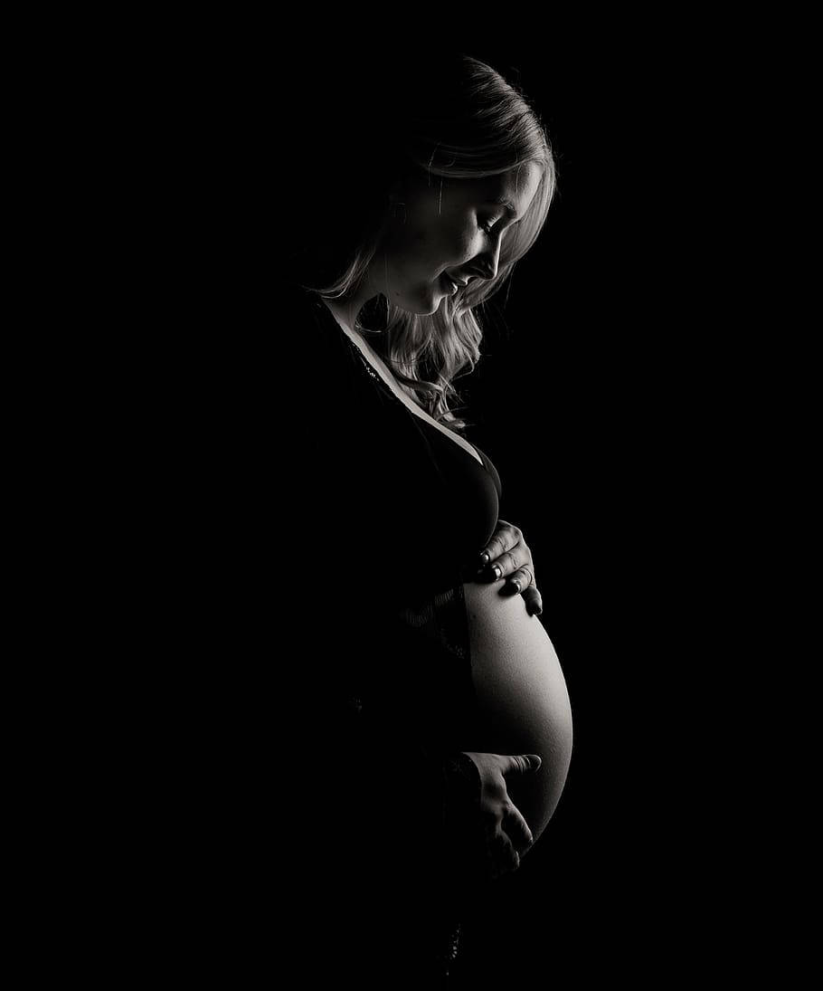pregnant belly, silhouette, stark black background, SD Phone Wallpaper