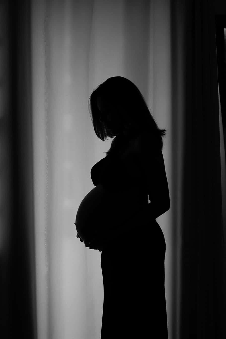 expectant mother silhouette, pregnant woman, cradling her belly, HD Phone Wallpaper