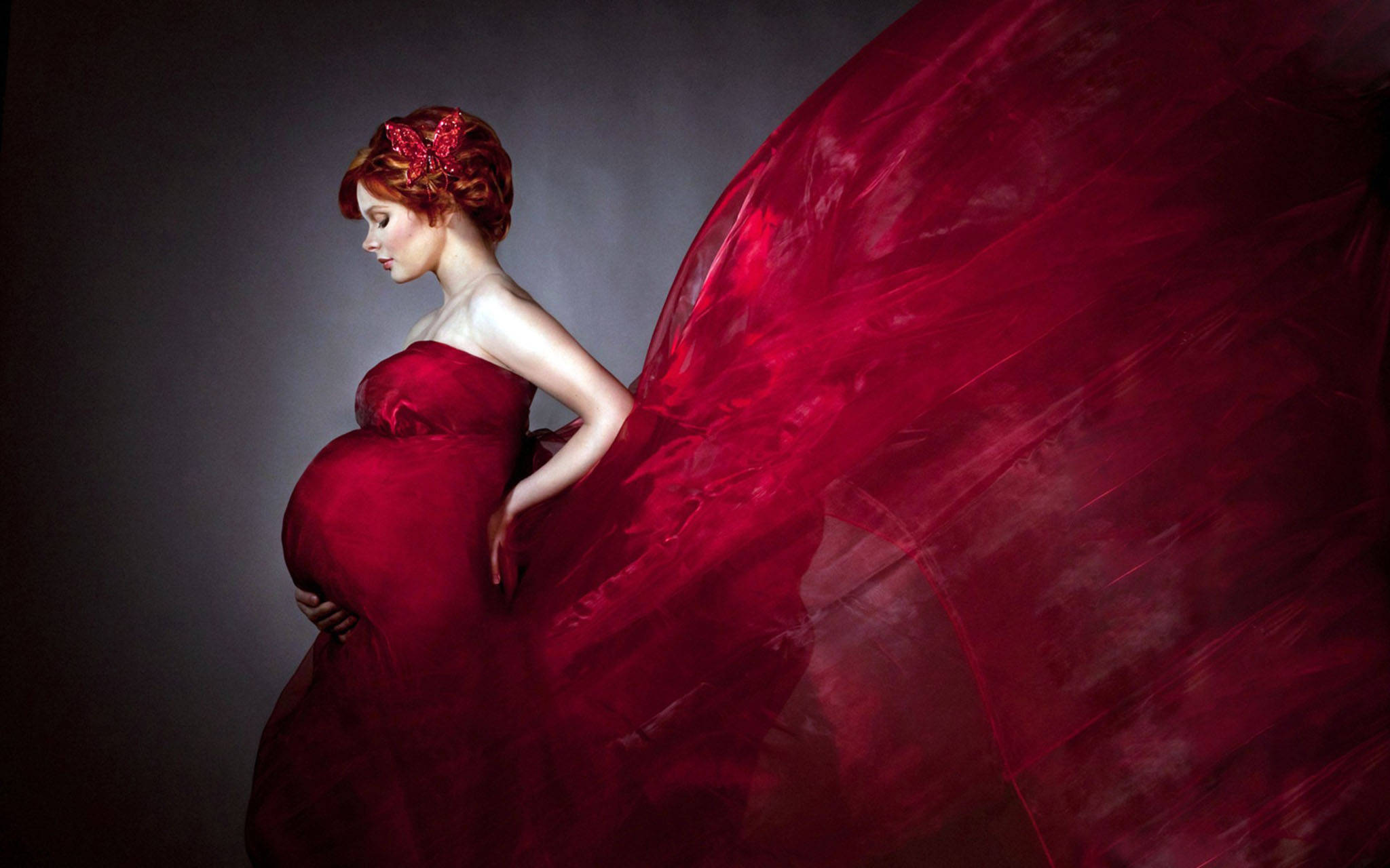pregnant woman, flowing red gown, dark gray backdrop, Full HD Desktop Wallpaper