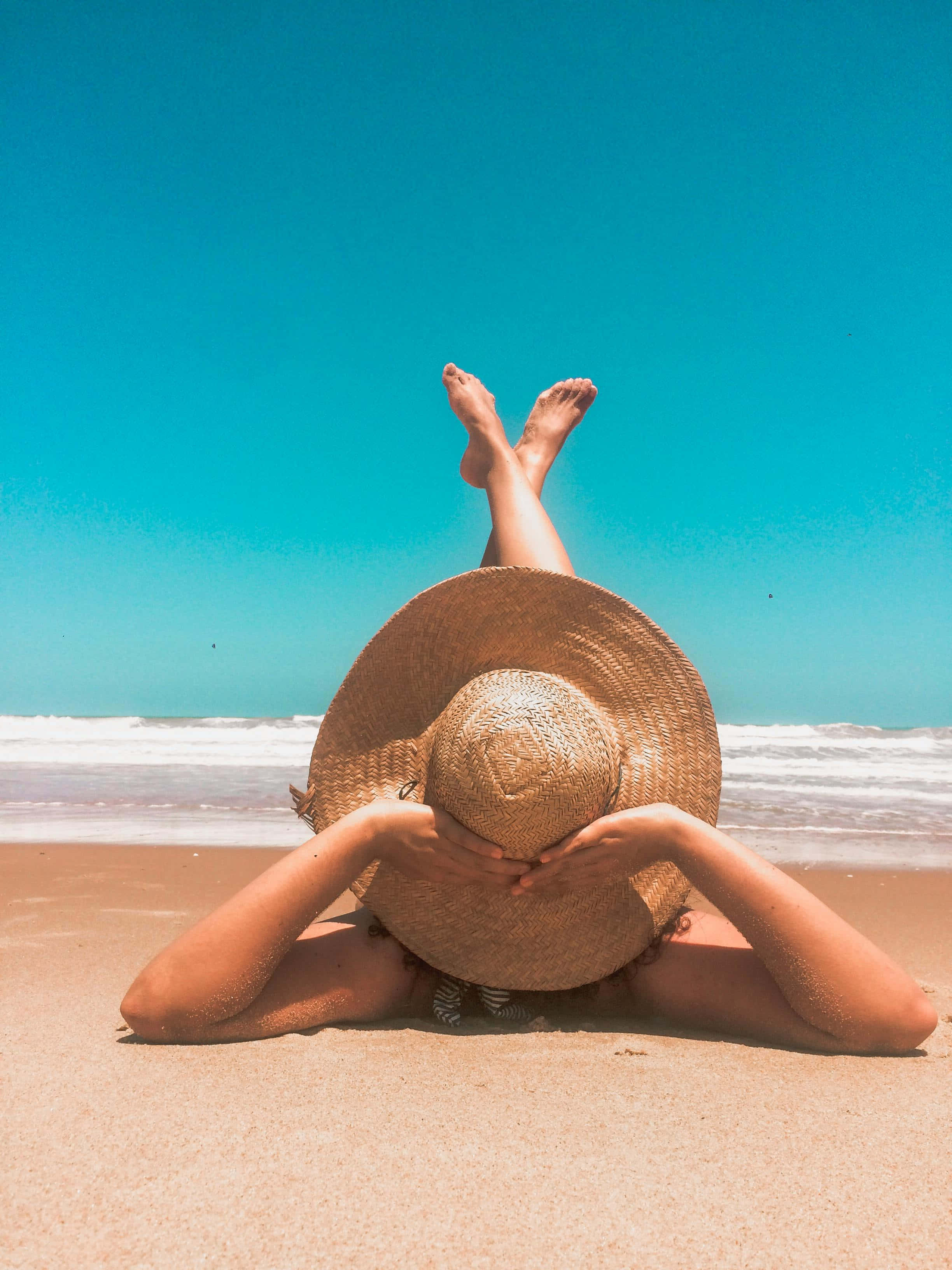 wide-brimmed straw hat, sandy beach, turquoise ocean, 2K Phone Wallpaper