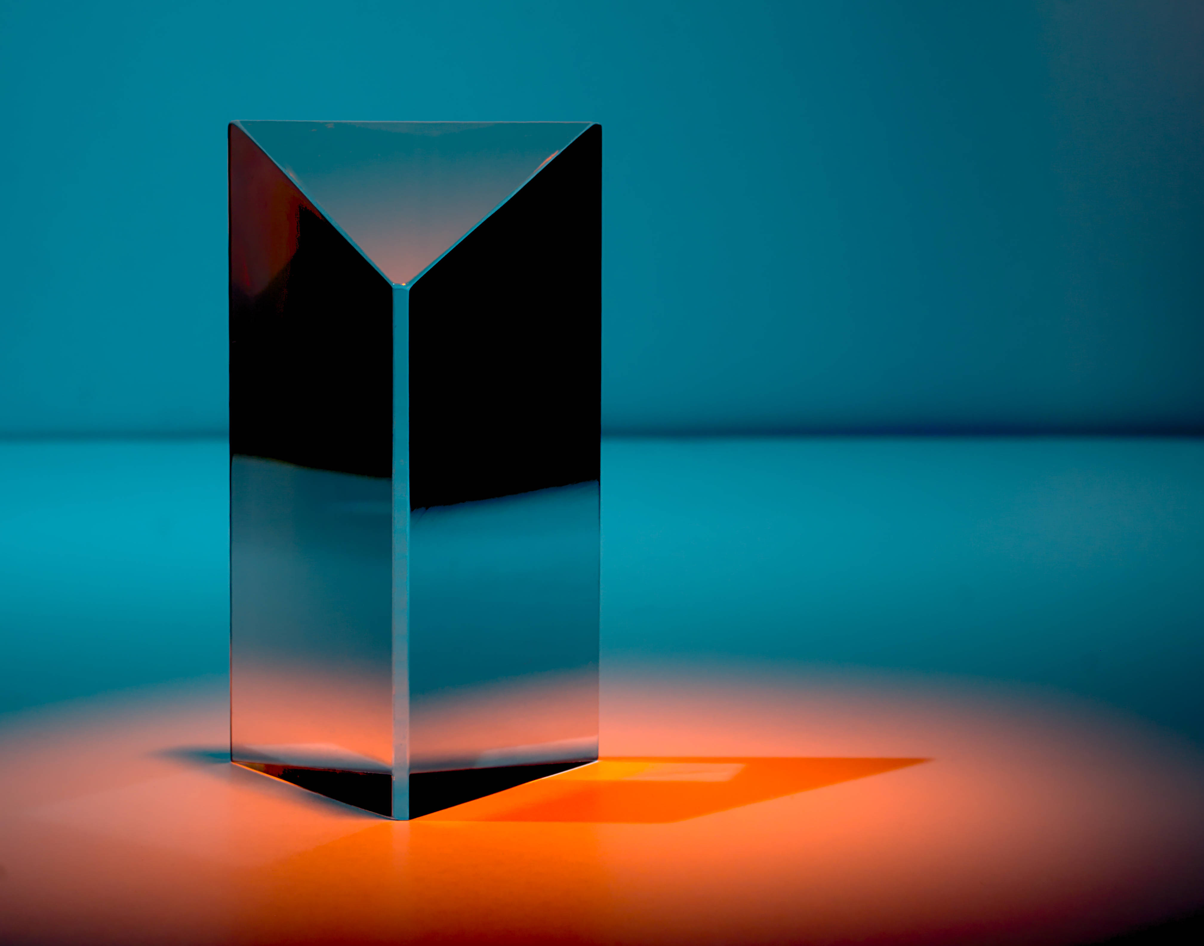 triangular mirror prism, warm orange light, cool blue gradient background, 4K Desktop Wallpaper
