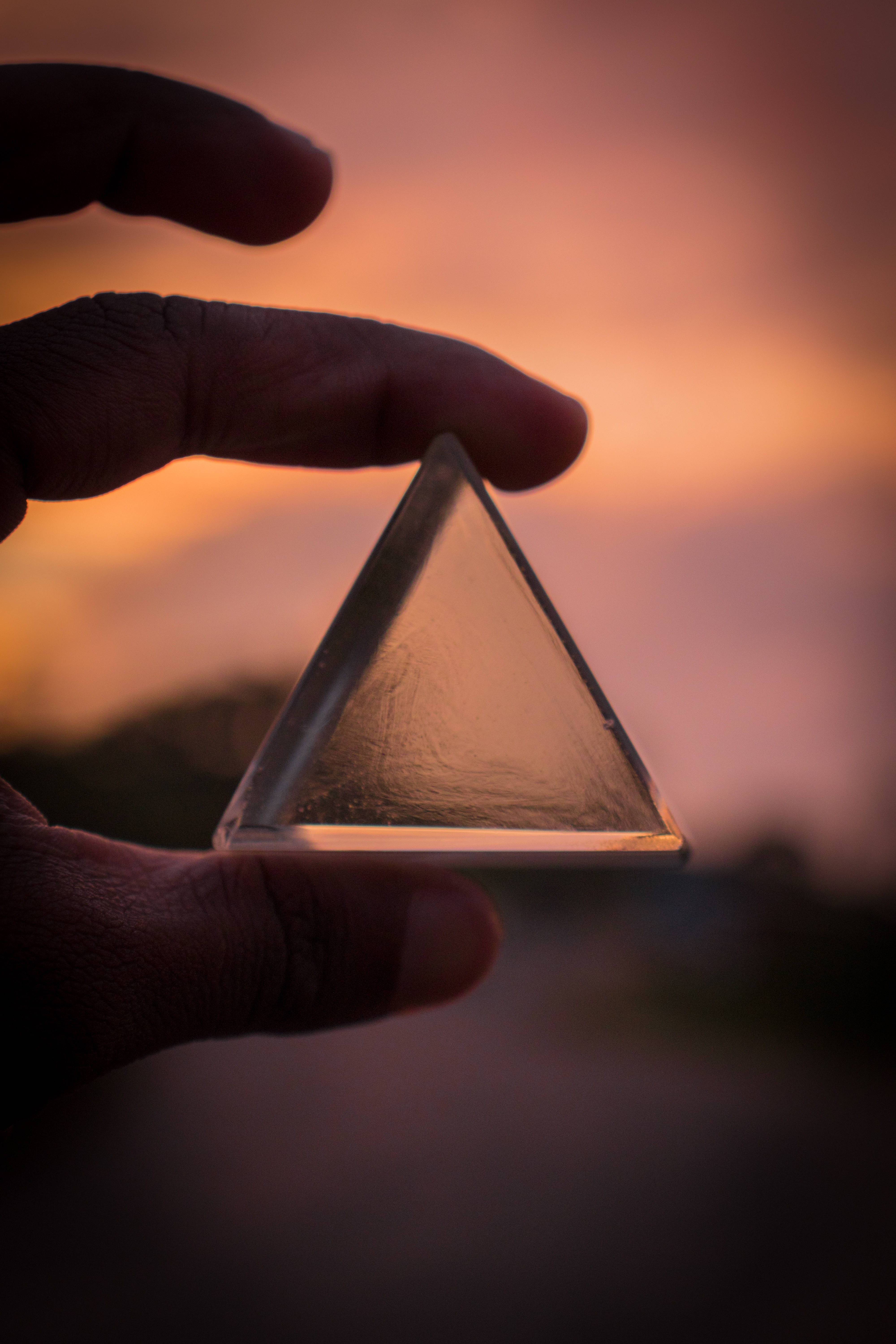 triangular glass prism, clear glass pyramid, warm sunset sky, 5K Phone Wallpaper