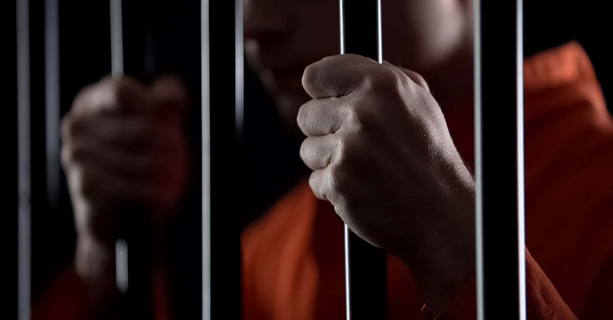 orange jumpsuit, metal bars, dimly lit jail cell, SD Desktop Wallpaper