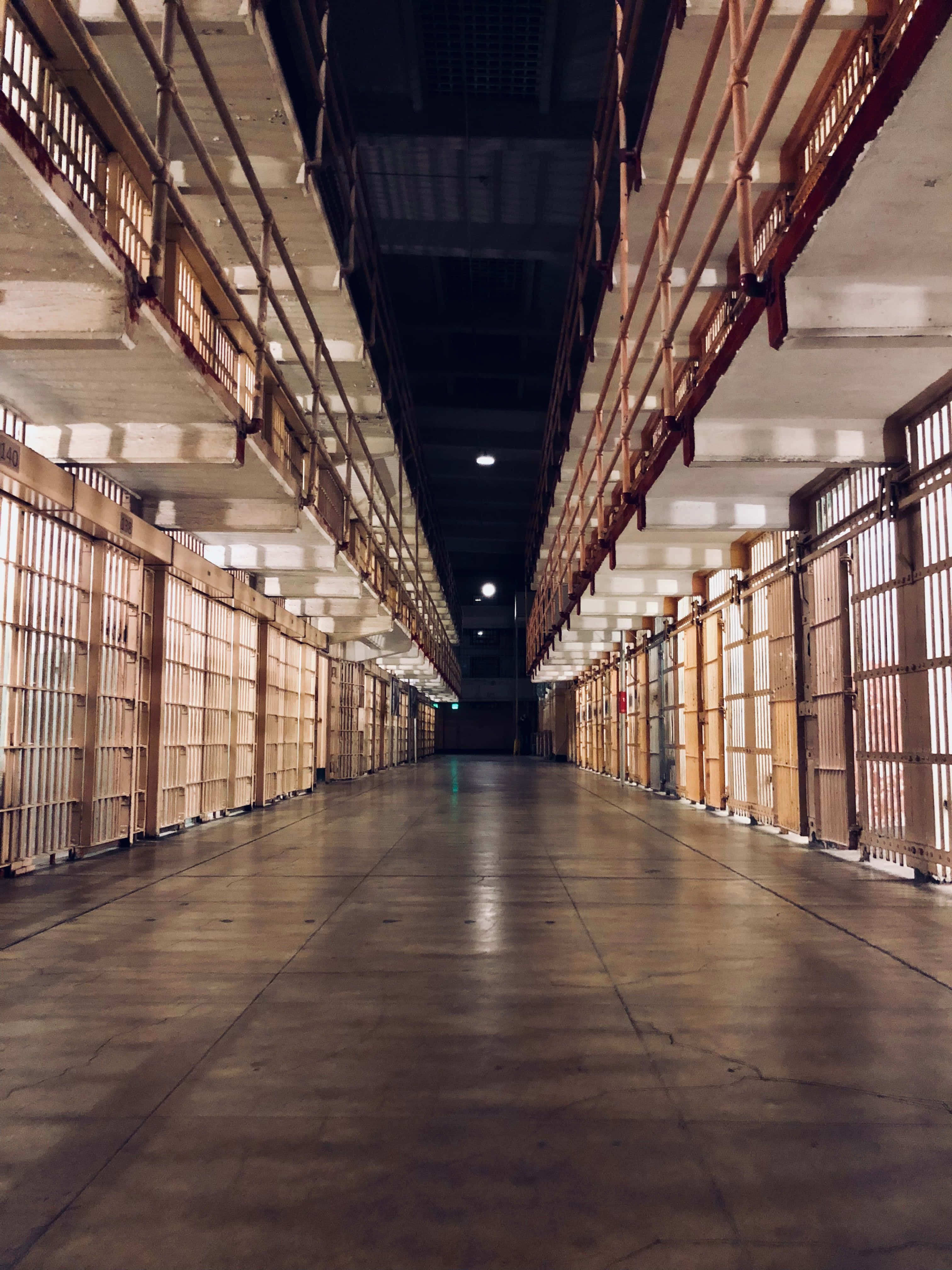 Solitary Prison Cell, wooden barred cells, dim overhead lights, 4K Phone Wallpaper