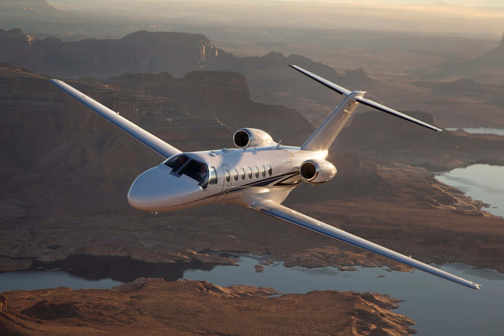 private jet, sleek white, rugged canyon landscape, Full HD Desktop Wallpaper