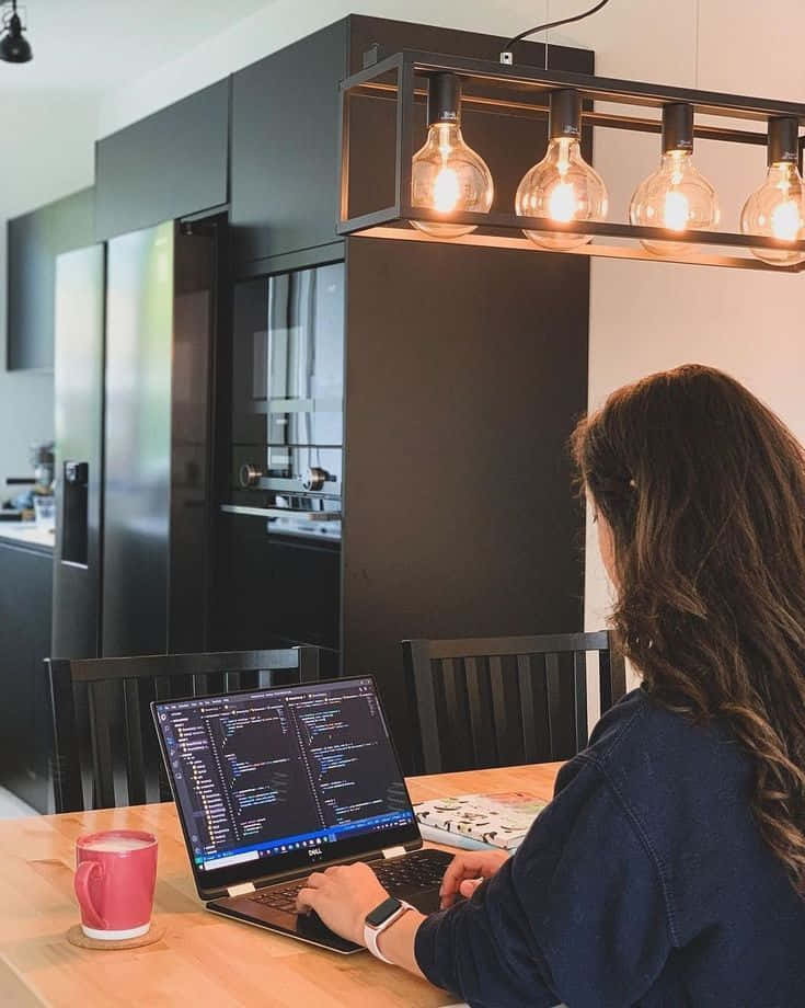 long brown hair, laptop displaying code, wooden table, SD Phone Wallpaper