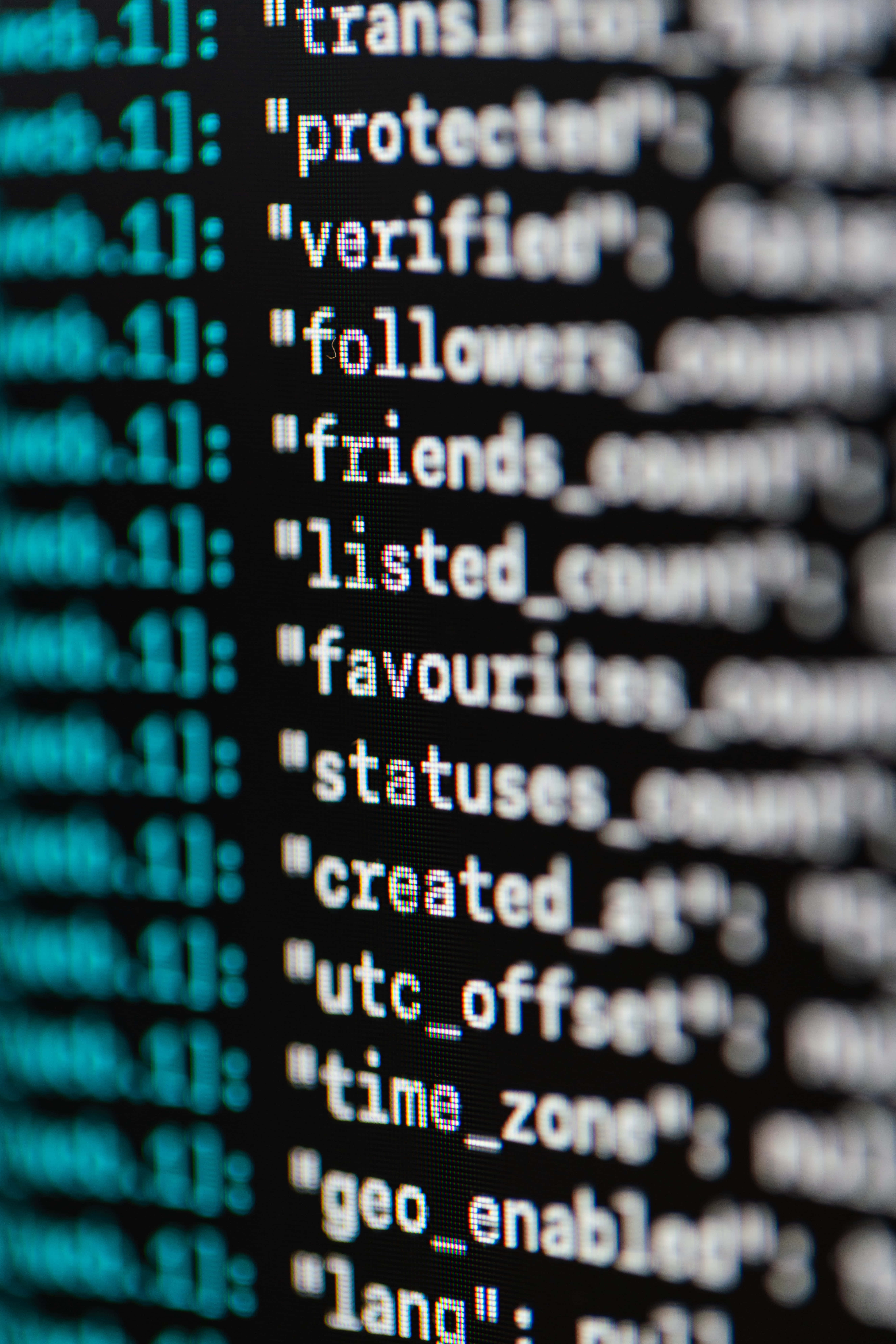 glowing teal and white JSON code, dark screen, shallow depth of field, 8K Phone Wallpaper