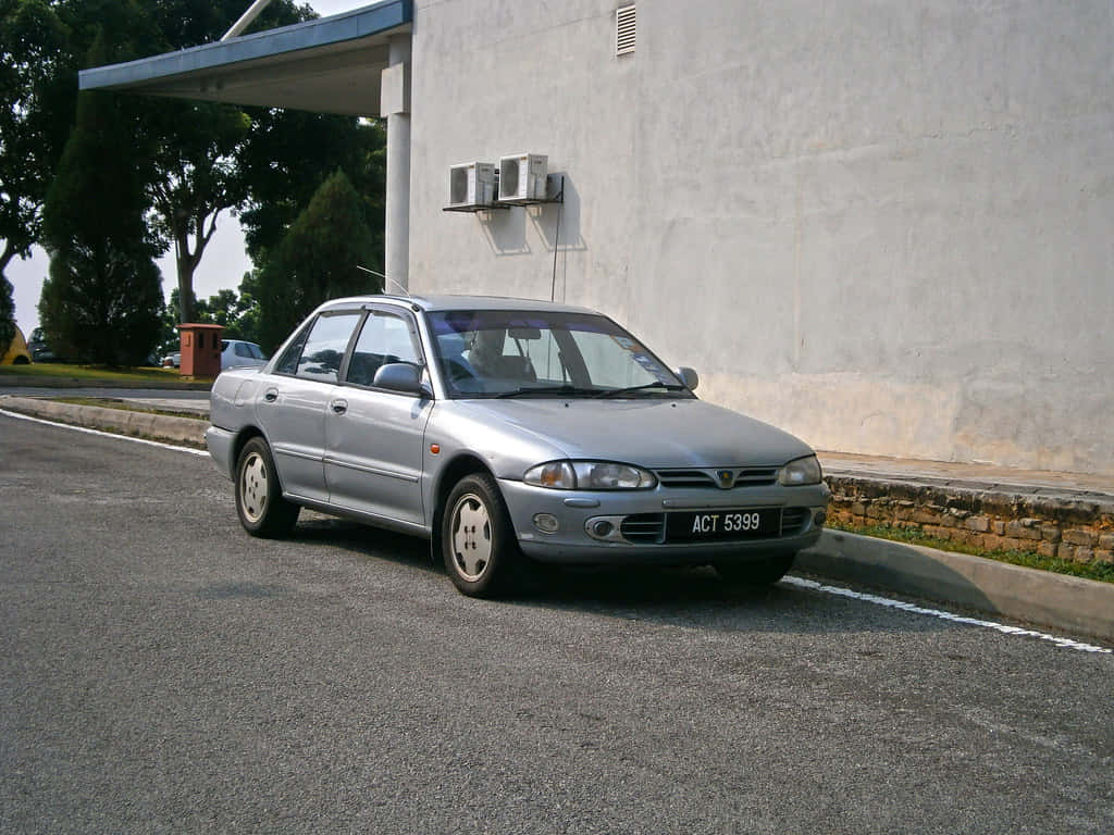 Silver Proton Wira, paved road, plain concrete wall, SD Desktop Wallpaper