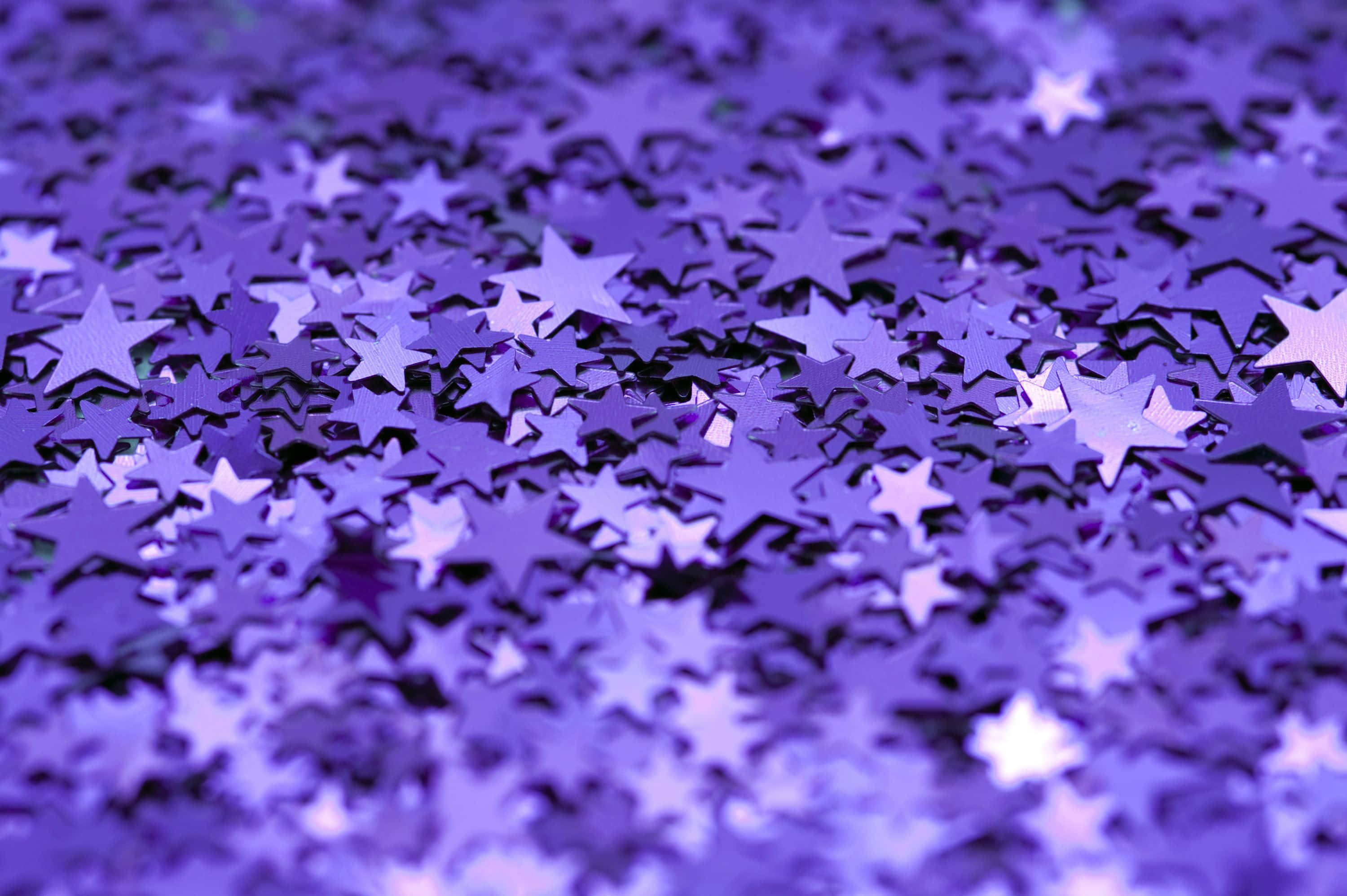 purple aesthetics computer, shimmering purple star-shaped confetti, soft depth of field, 2K Desktop Wallpaper
