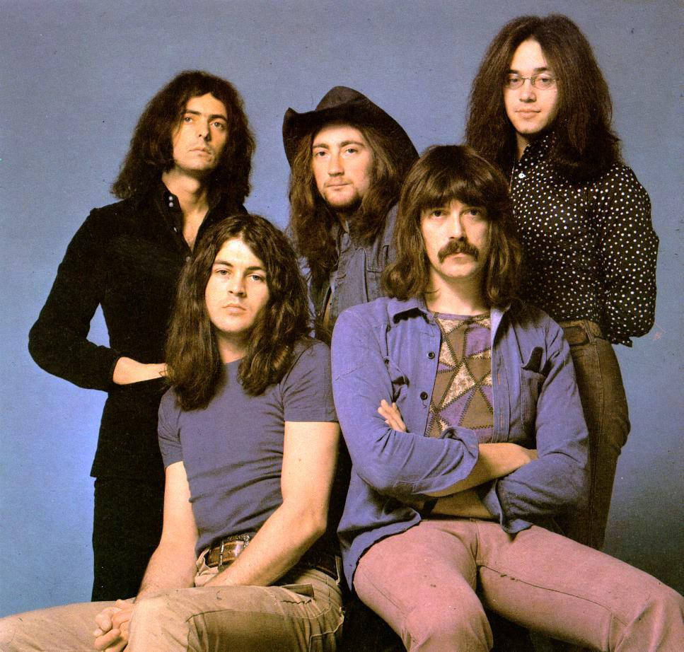 Deep Purple, 1970s rock attire, solid blue studio backdrop, SD Desktop Wallpaper